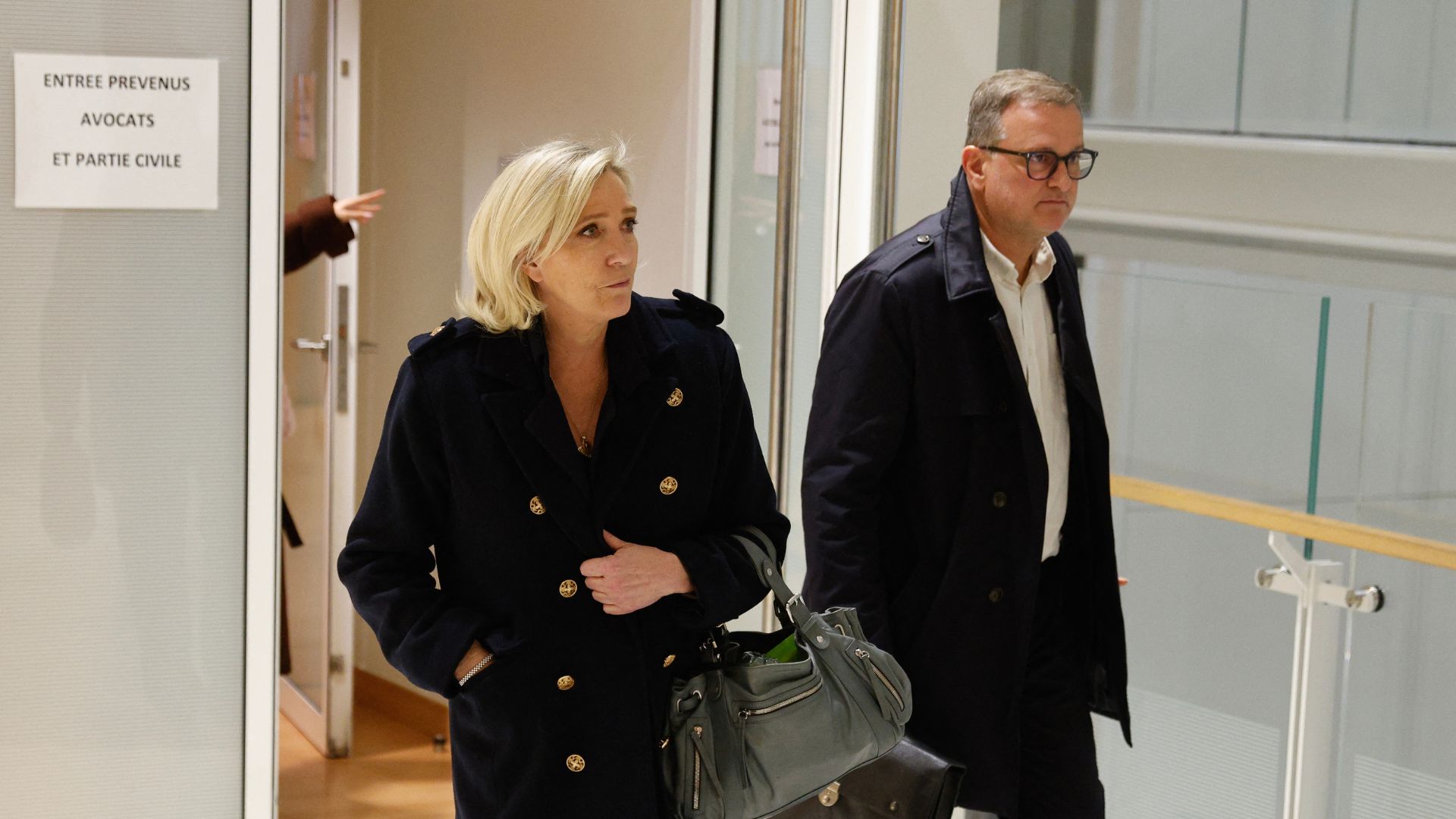 Le Pen (L) and French far-right party RN vice president Louis Aliot (R) walk outside the courtroom during a break in their trial on Wednesday.
/Geoffrey Van Der Hasselt/AFP
