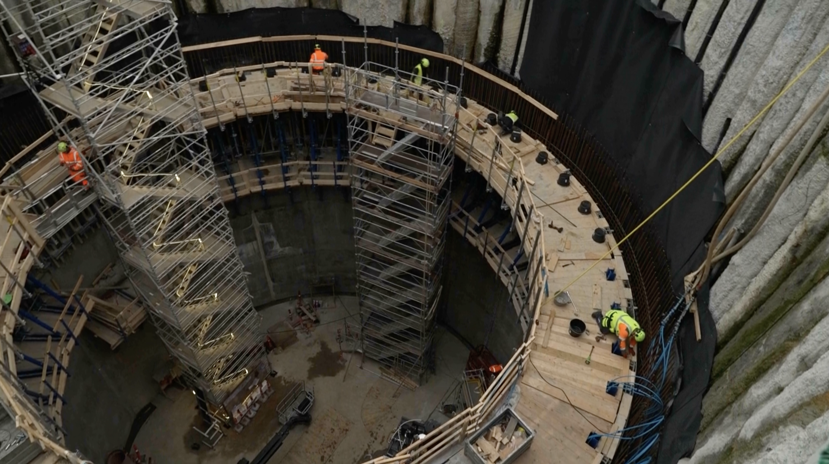 Workers are seen during construction of a vertical section of the tunnel. /AP