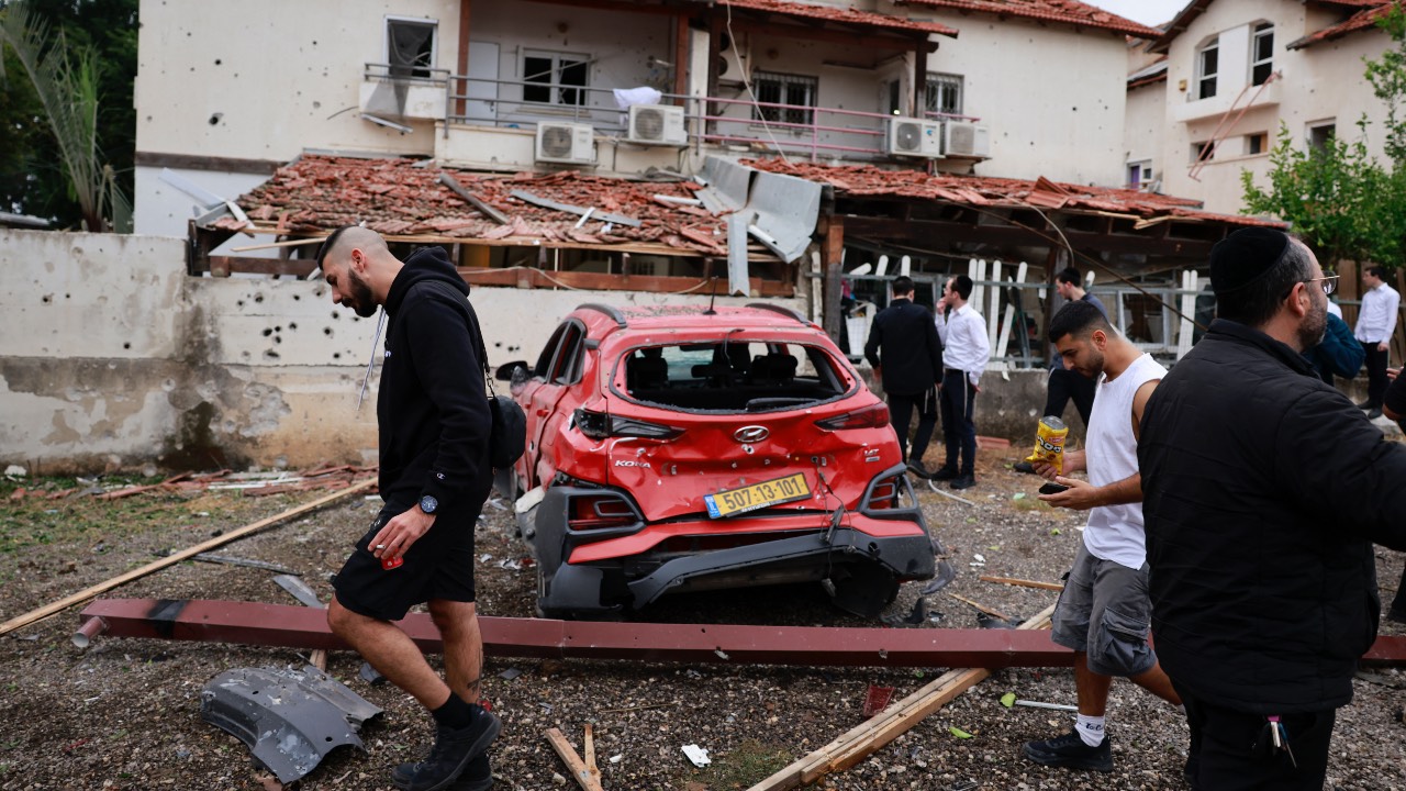 Residents in Petah Tikva near Tel Aviv check the damage after rockets were fired from Lebanon. /Menahem Kahana/AFP