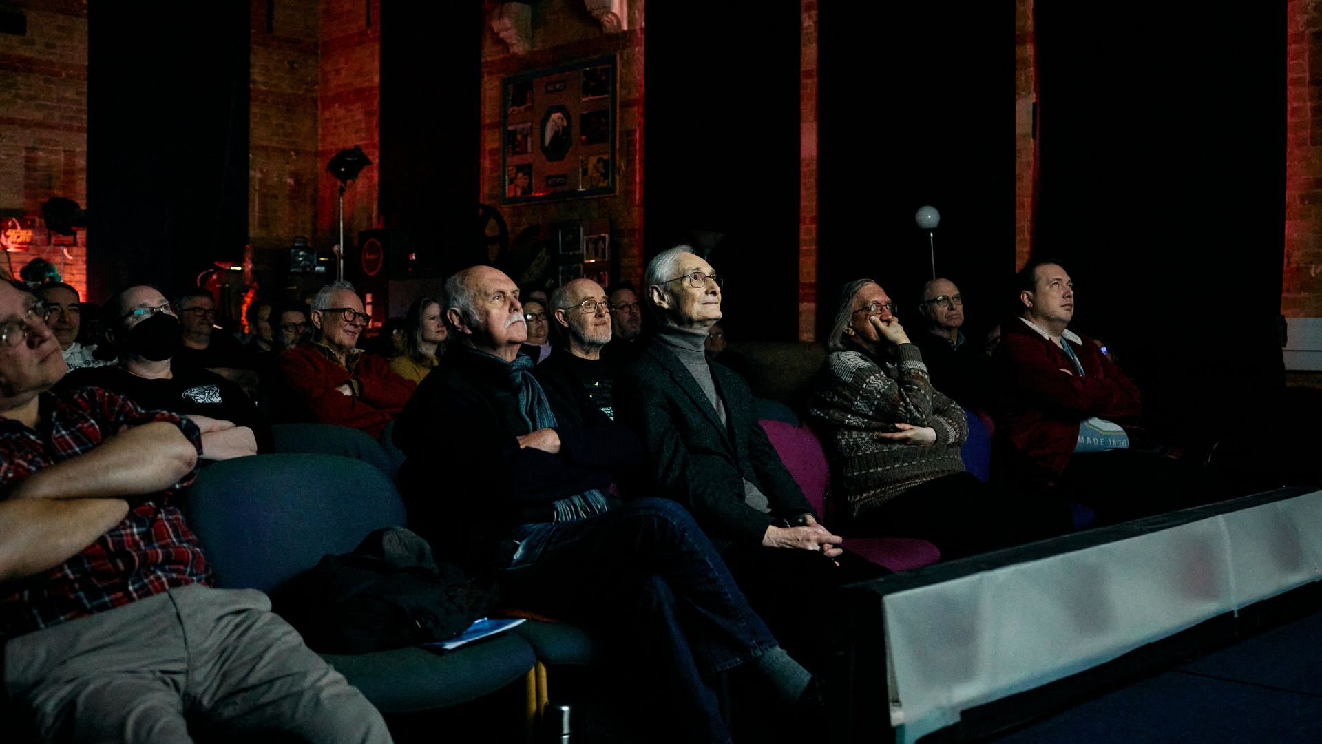 People attend a projection of the Danish silent movie 'The Mannequins' accompanied by a live piano performance, at the Cinema Museum.
/Benjamin Cremel/AFP
