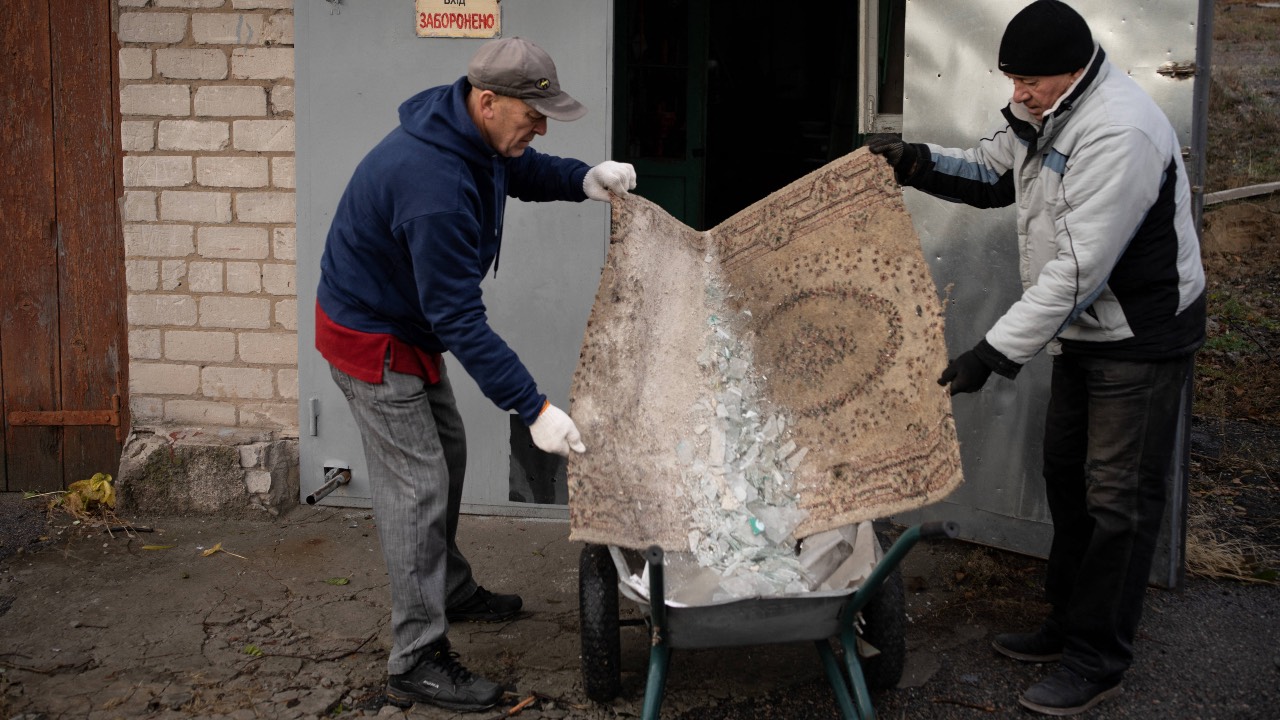 Men clean a damaged rehabilitation centre for people with disabilities, following a Russian attack in the Ukrainian city of Dnipro, on November 22. /Florent Vergnes/AFP