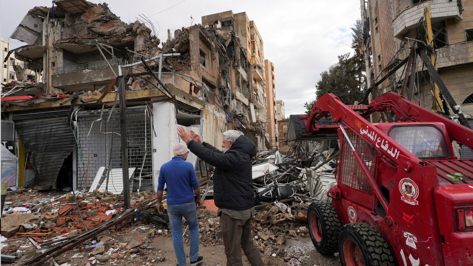 Civil defense members clear a road at a damaged site following Israeli strikes on Beirut's southern suburbs on Monday. /Mohammed Yassin/Reuters
