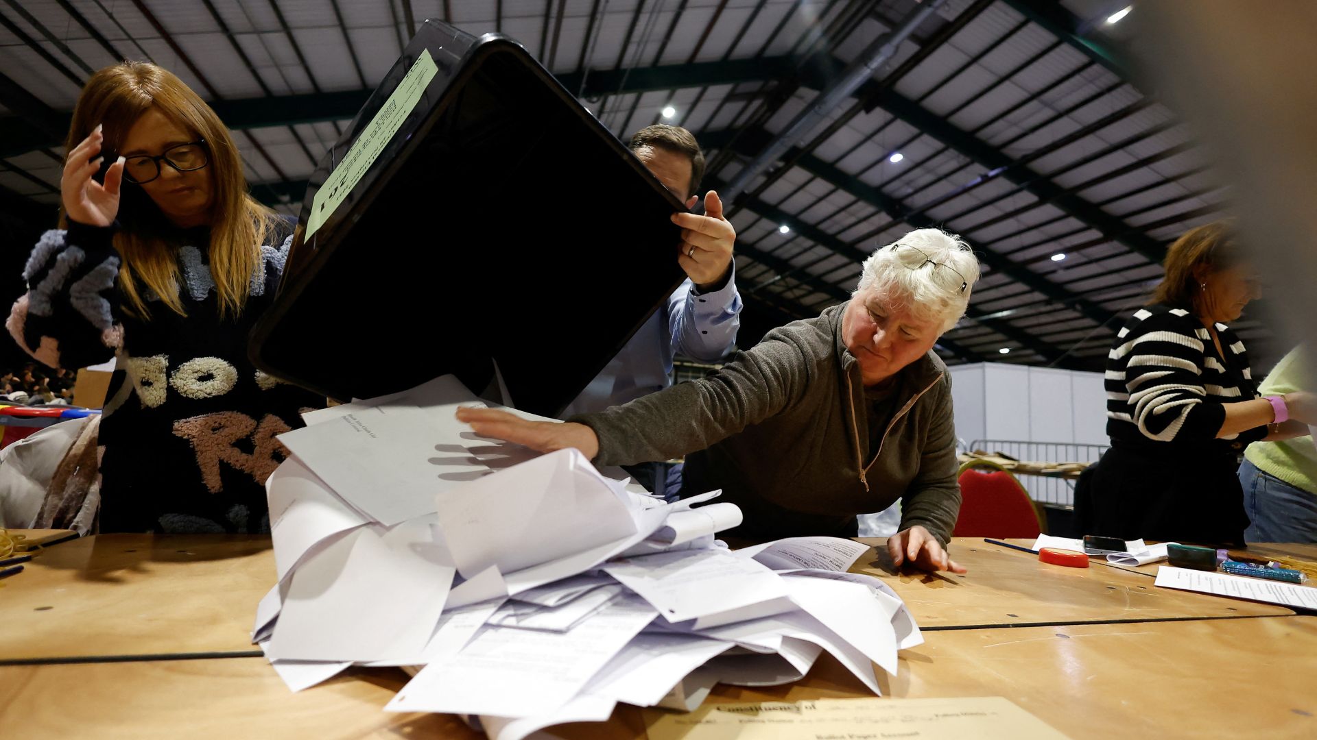 Electoral workers sort through ballot papers, during Ireland's general election, at the Royal Dublin Society (RDS) count centre. /Clodagh Kilcoyne/Reuters