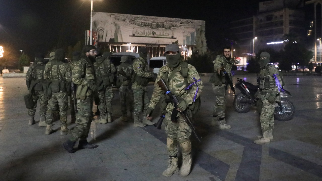 Syrian opposition fighters gather at Saadallah al-Jabiri Square, after rebels opposed to Syria's President Bashar al-Assad said they had reached the heart of Aleppo, Syria. /Mahmoud Hasano/Reuters