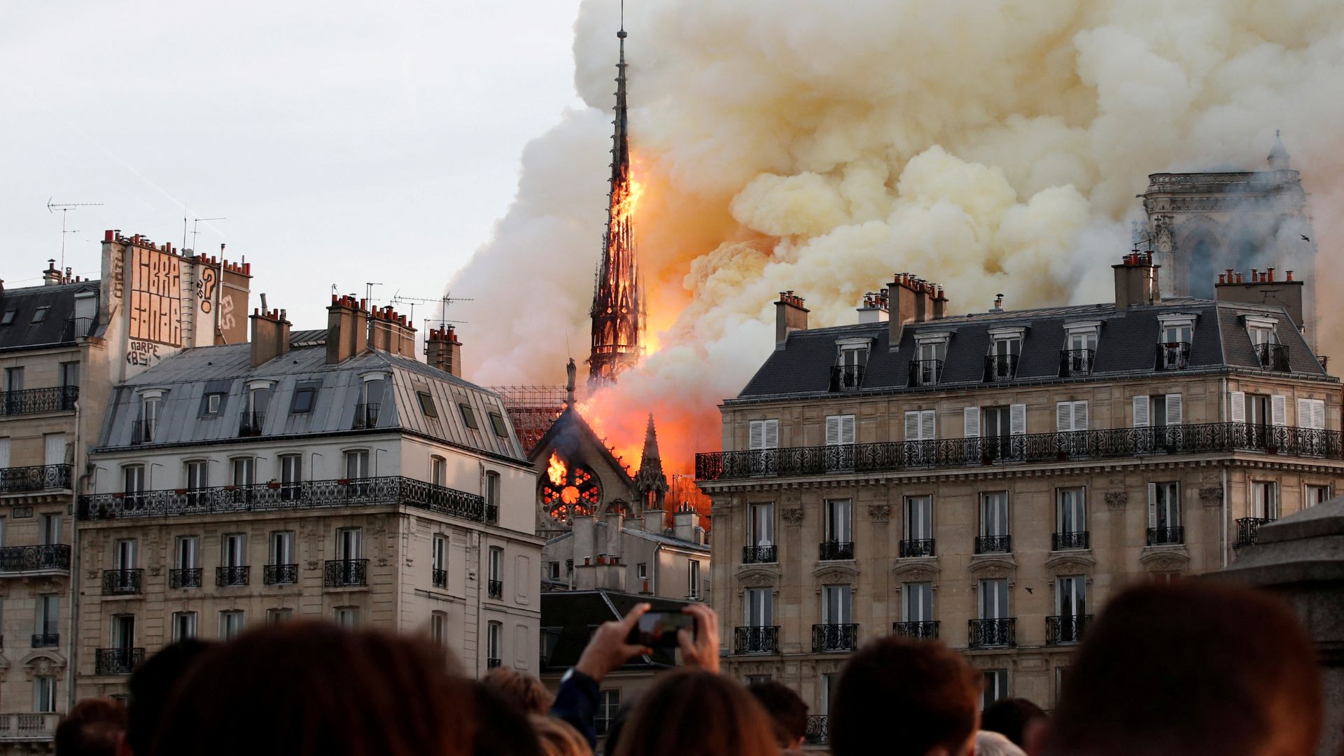 This picture of the 2019 fire shows how central the cathedral is – and how horrified crowds gathered to watch it burn. /Benoit Tessier/Reuters
