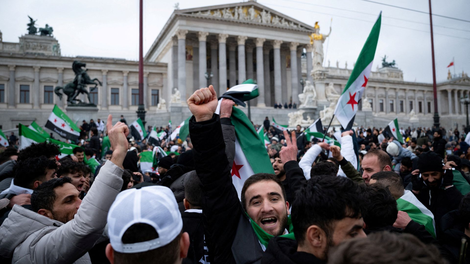 On Sunday, Syrians in Vienna celebrated the power transition in their home country. Within 24 hours, they were told they might have to go back there. /Elisabeth Mandl/Reuters
