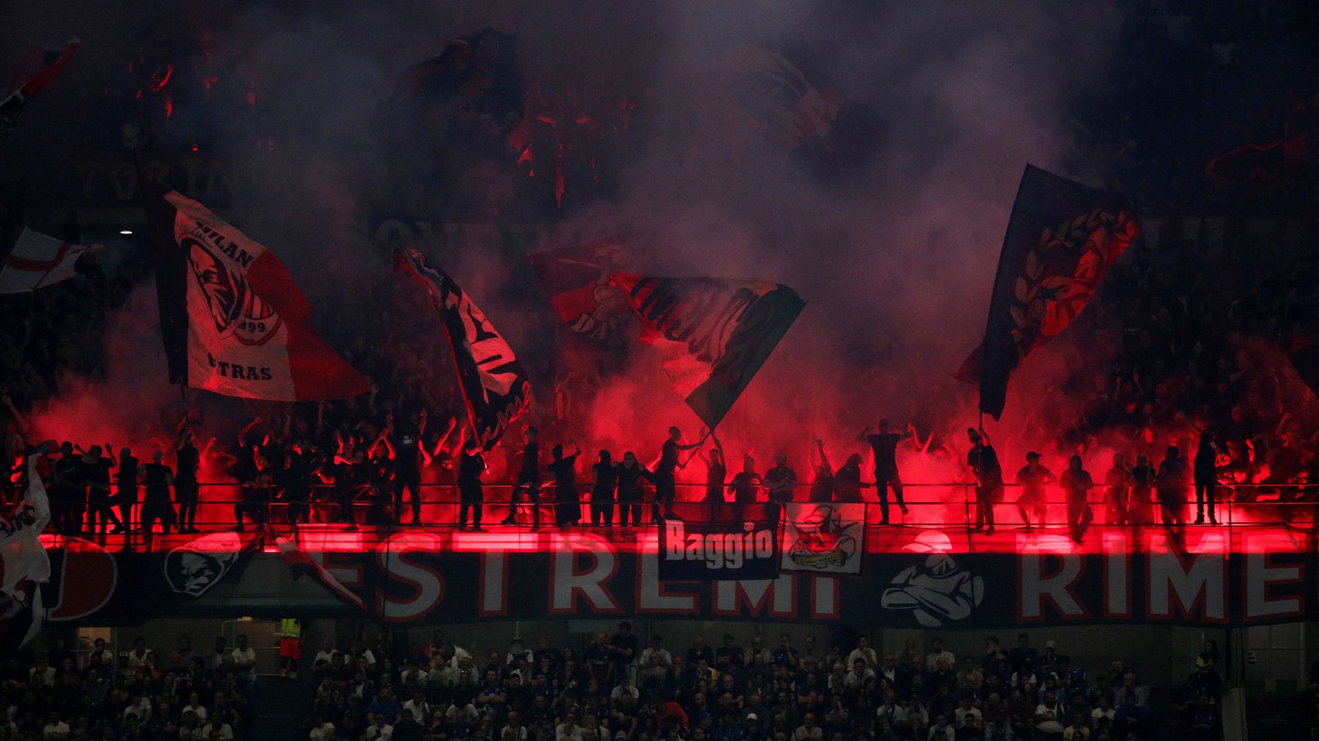 AC Milan fans with flares during the local derby match against Inter. /Alessandro Garofalo/Reuters
