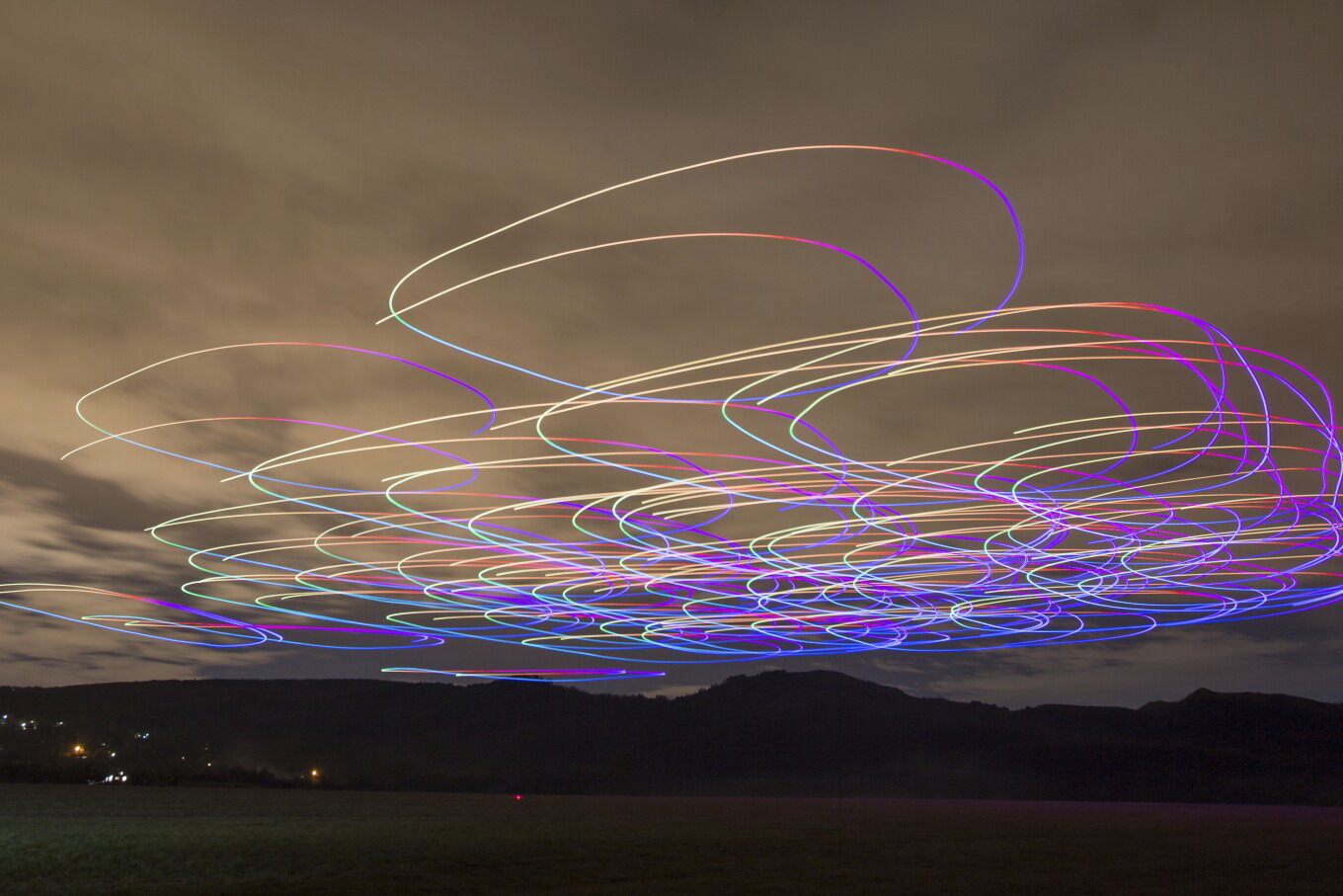 A long-exposure shot shows the flight of a flock of autonomous drones during an experiment near Budapest. /HO/Eotvos Lorand University/AP Photo
