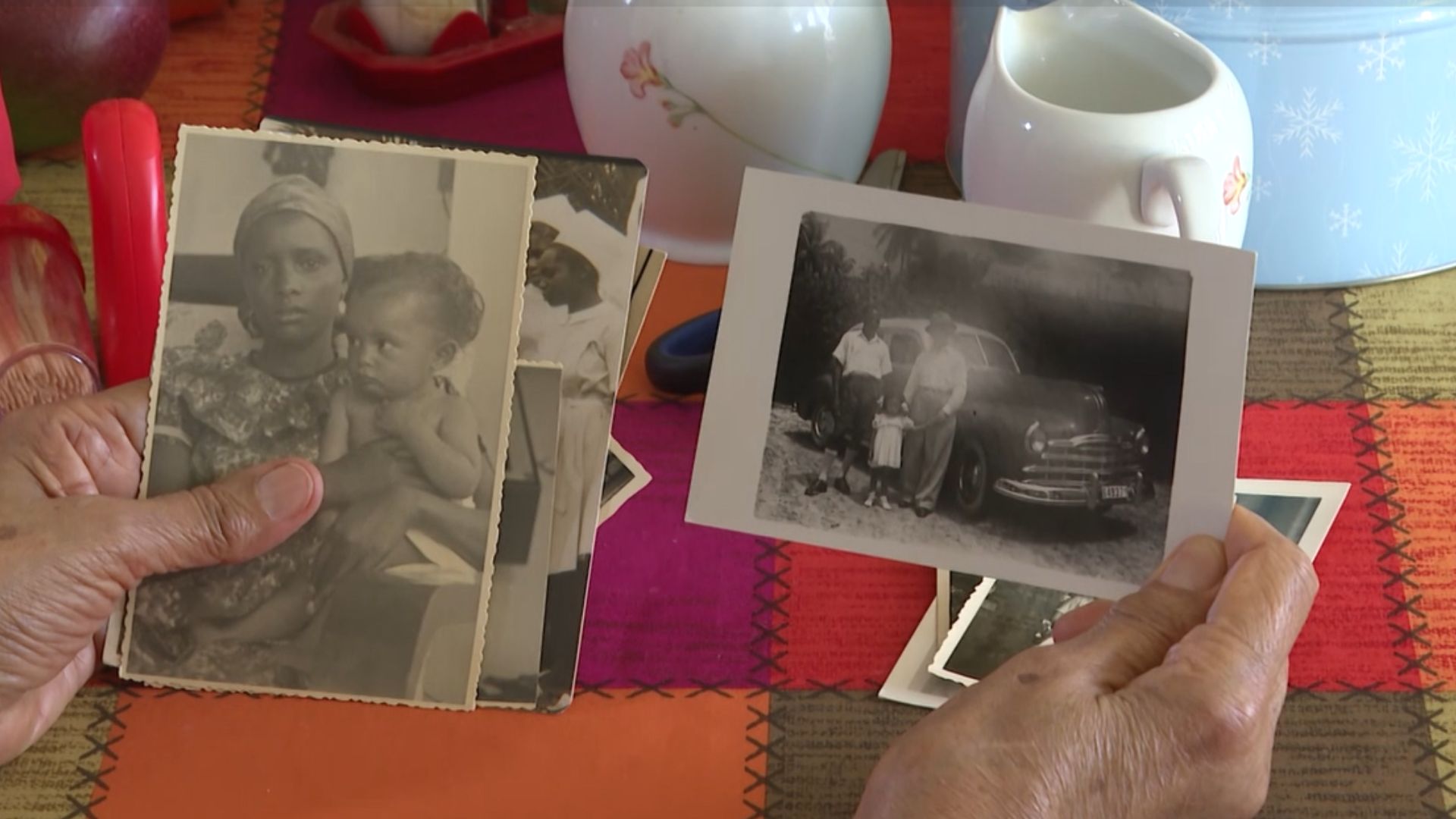 Verbeken holding photographs of herself as a child. /CGTN