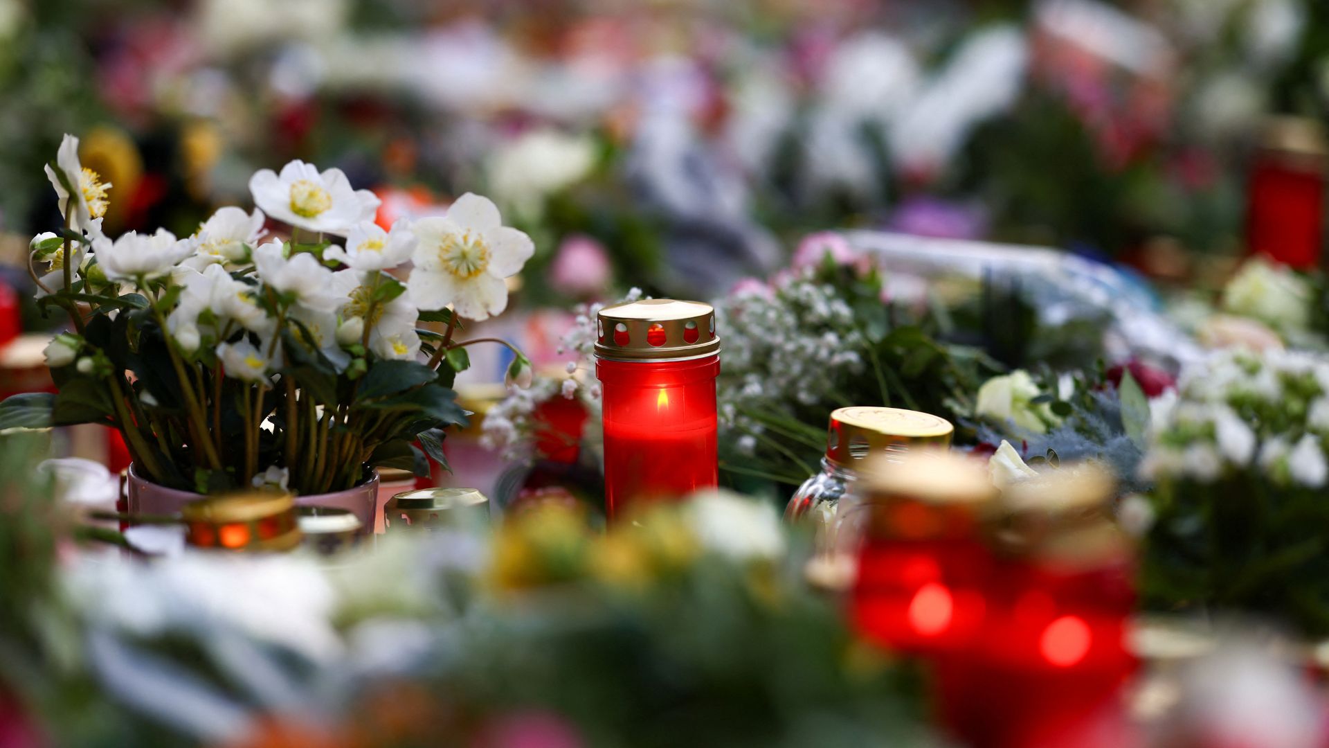 Candles and floral tributes lie near the site where a car drove into a crowd at a Magdeburg Christmas market. /Christian Mang/Reuters