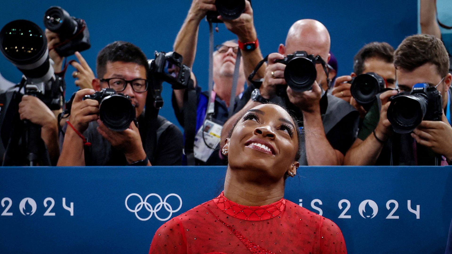 Biles reacts after her performance in France. /Hannah Mckay/Reuters