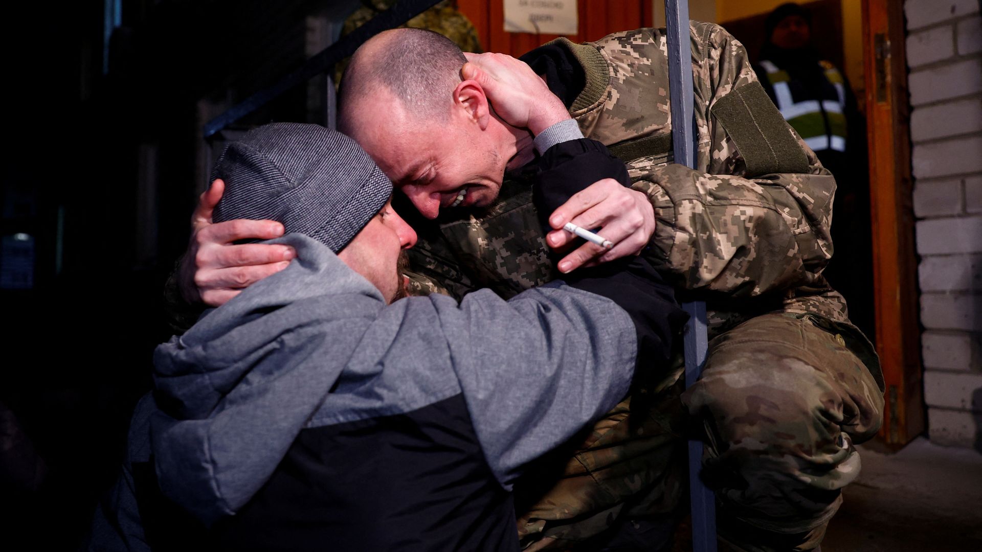 Yevhen, a Ukrainian prisoner of war (POW), embraces his friend, a former POW, as he returns after a swap, in an undisclosed location in Ukraine, December 30, 2024. /Valentyn Ogirenko/Reuters
