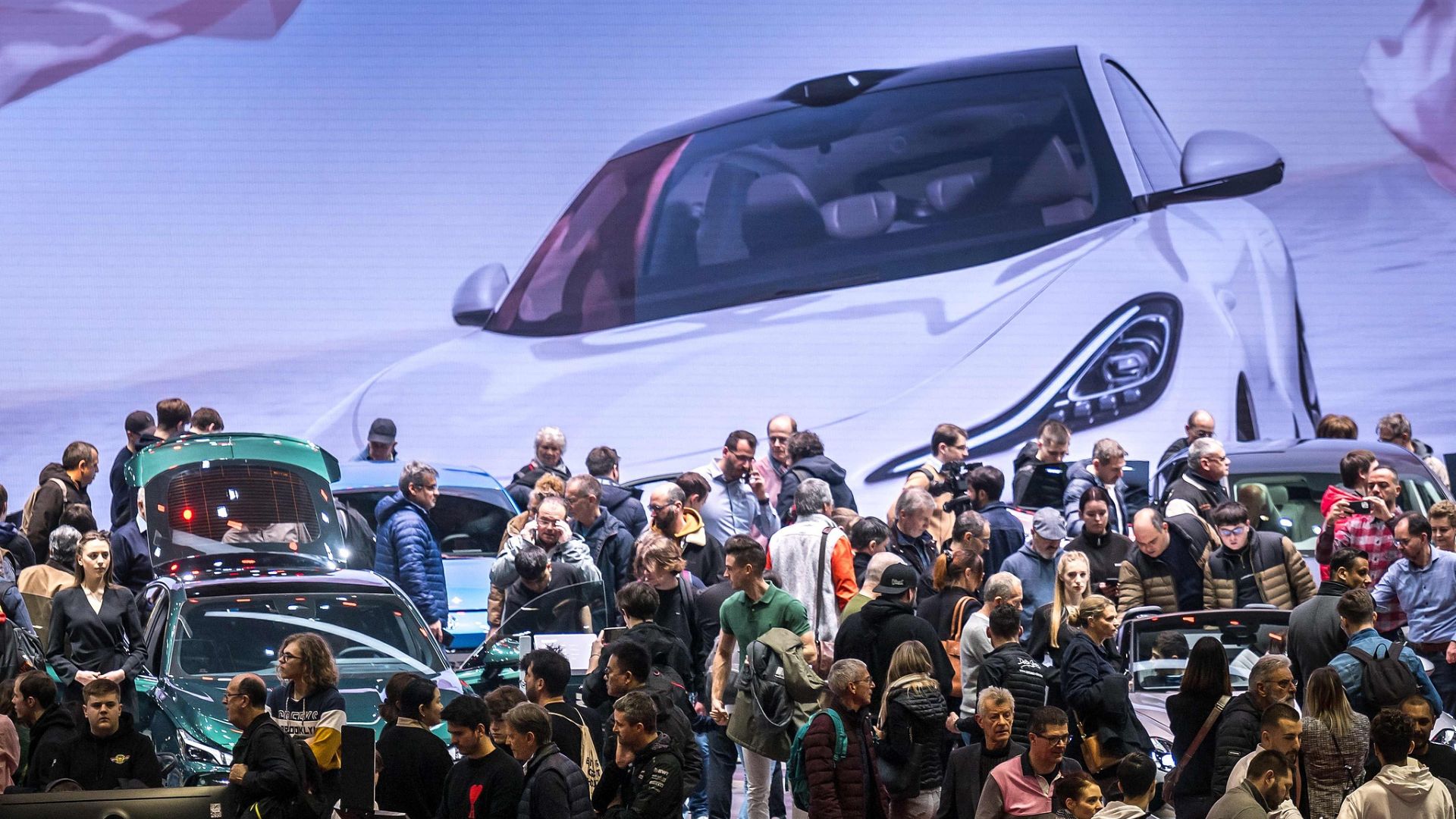 Visitors are seen at the stand of MG Motor company owned by Chinese carmaker SAIC at the Geneva International Motor Show last February. /Fabrice Coffrini/CFP
