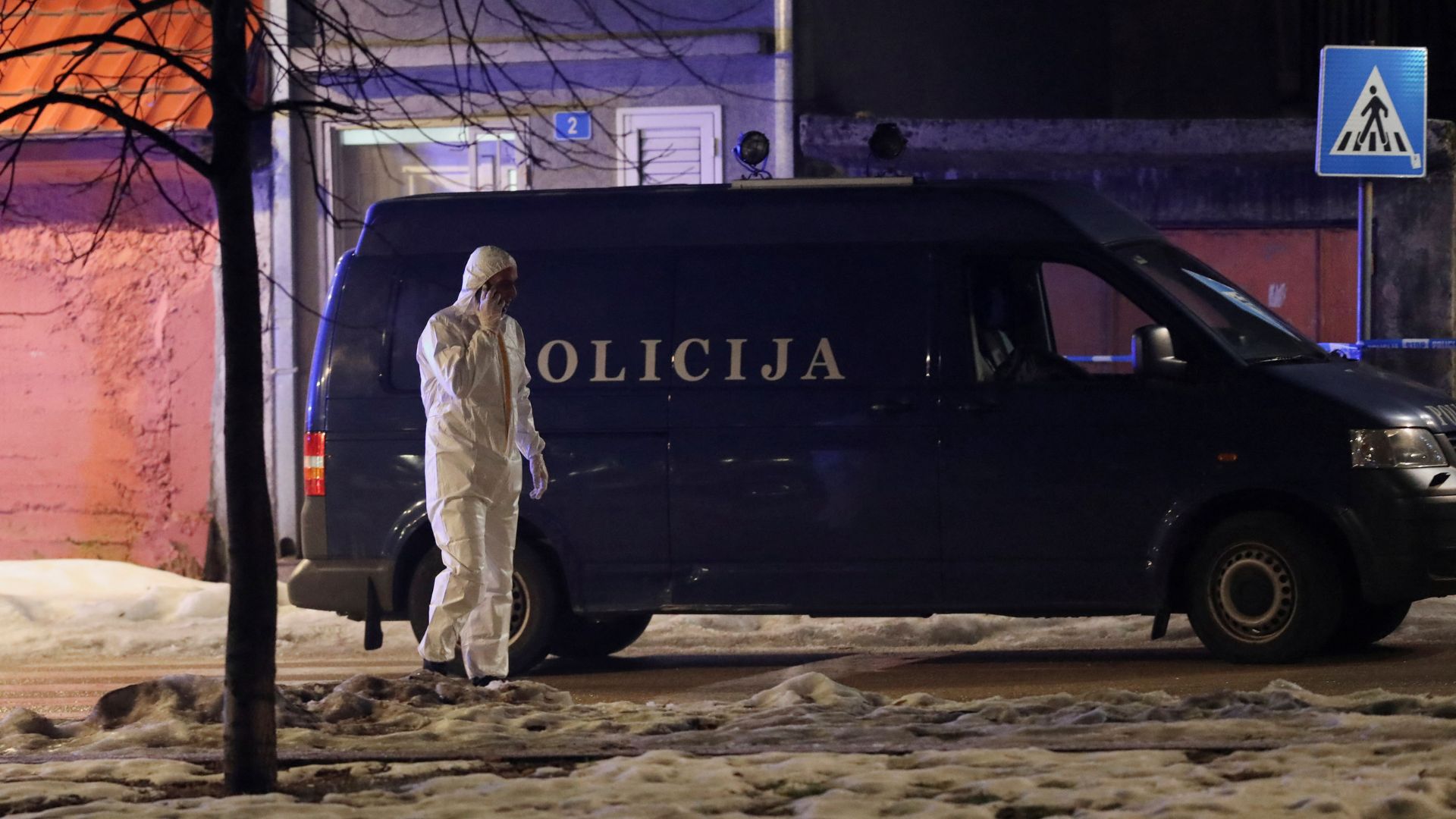 A forensic technician speaks on the phone on a street near the scene where a gunman opened fire at a restaurant and killed several people. /Stevo Vasiljevic/Reuters