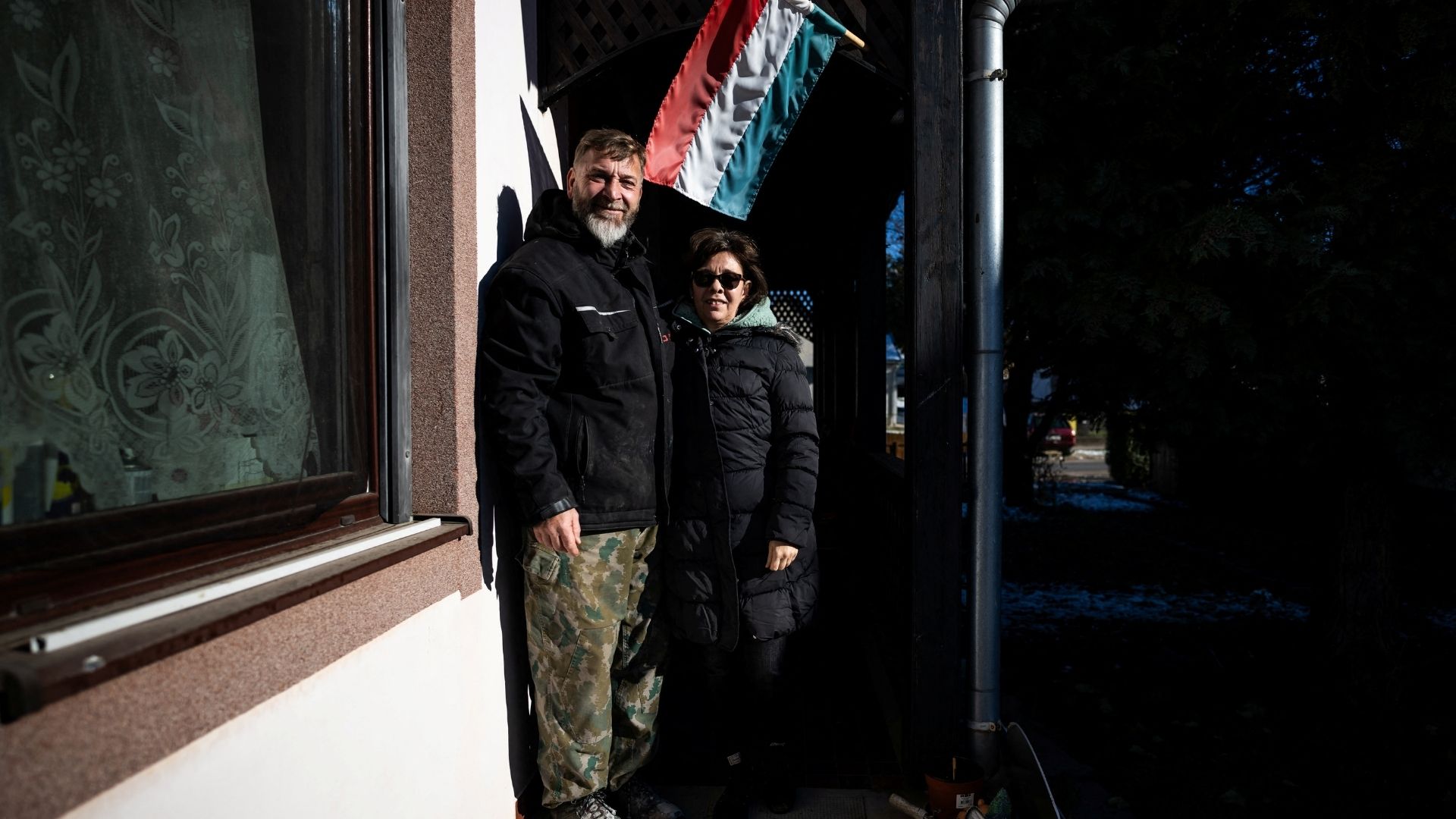 Andre and Ines Iwan pose for a picture at the door of their home in Szolosgyorok, Hungary. /Marton Monus/Reuters
