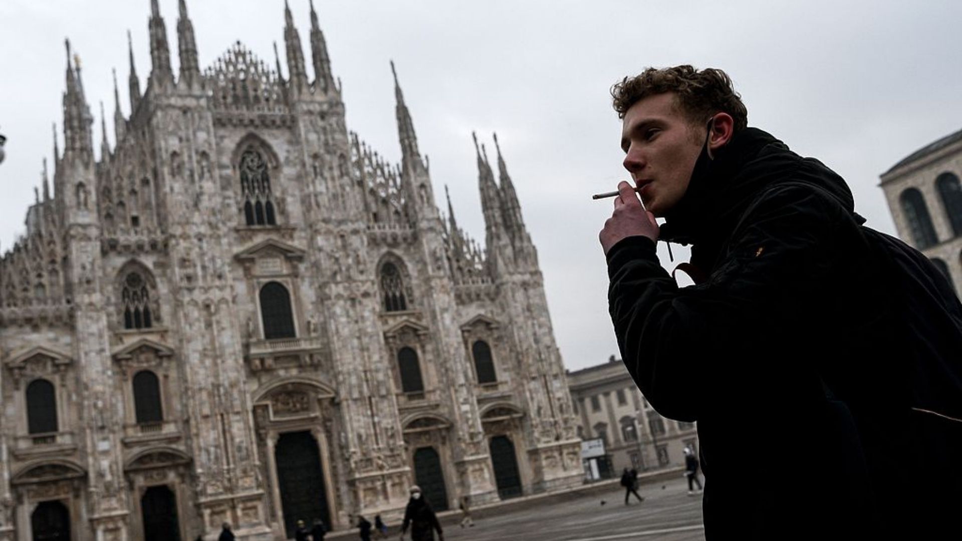 A man smokes a cigarette on Milan's Piazza del Duomo... in 2021. /Piero Cruciatti/CFP