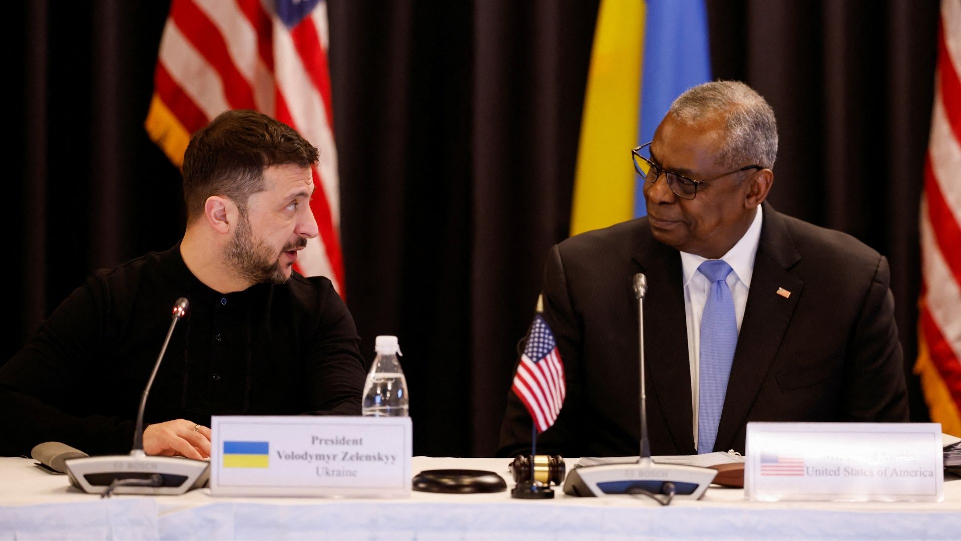 Zelenskyy and Austin chat at the Ramstein air base in Germany. /Heiko Becker/Reuters
