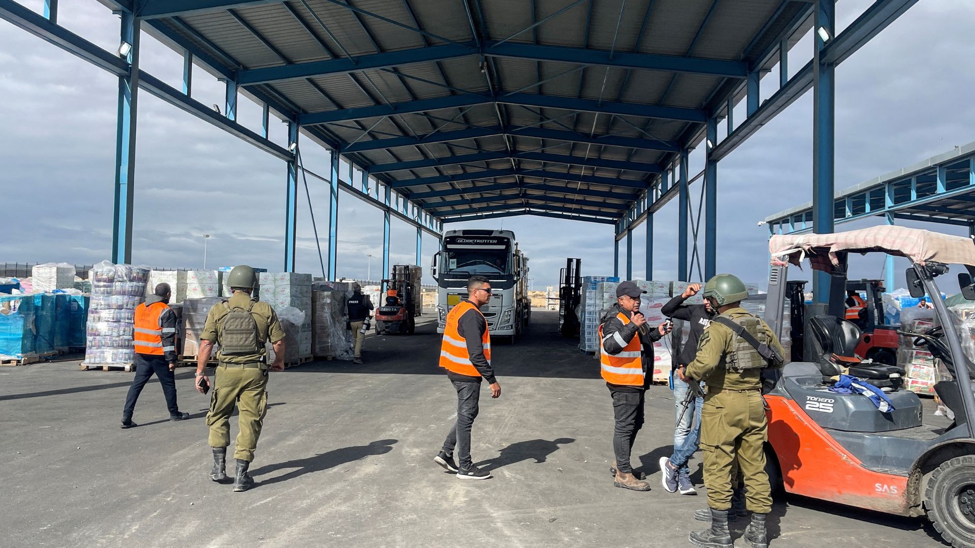 Israeli soldiers and workers gather near humanitarian aid at the Kerem Shalom distribution center in the Gaza Strip last November. /Jill Gralow
/Reuters