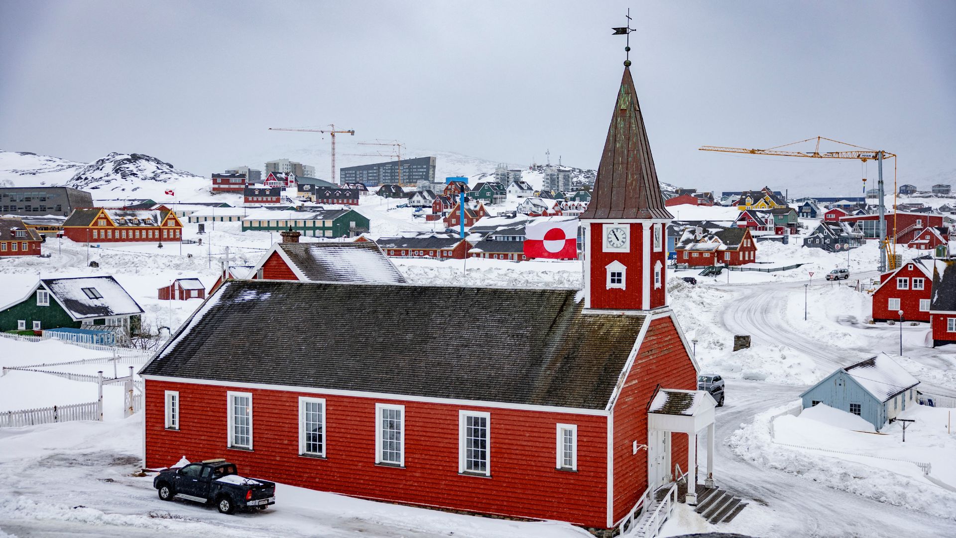 Greenland's flag flutters next to the Hans Egede Cathedral during Sunday service in Nuuk, Greenland, on March 9. /Odd Andersen/AFP
