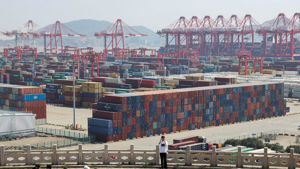 A photographer in front of thousands of cargo containers at the Yangshan Port outside of Shanghai. /Go Nakamura/Reuters 
