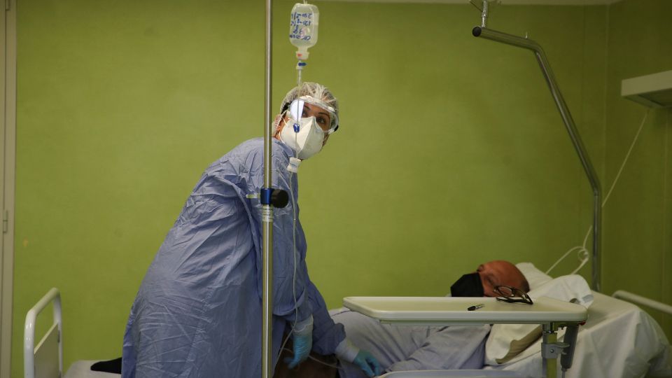 A medical health worker administers an intravenous dose of monoclonal antibody treatment to Antonio Rapuano, a COVID-19 patient, at San Giuseppe Hospital, in Albano, Italy in April 2021. /Yara Nardi/Reuters