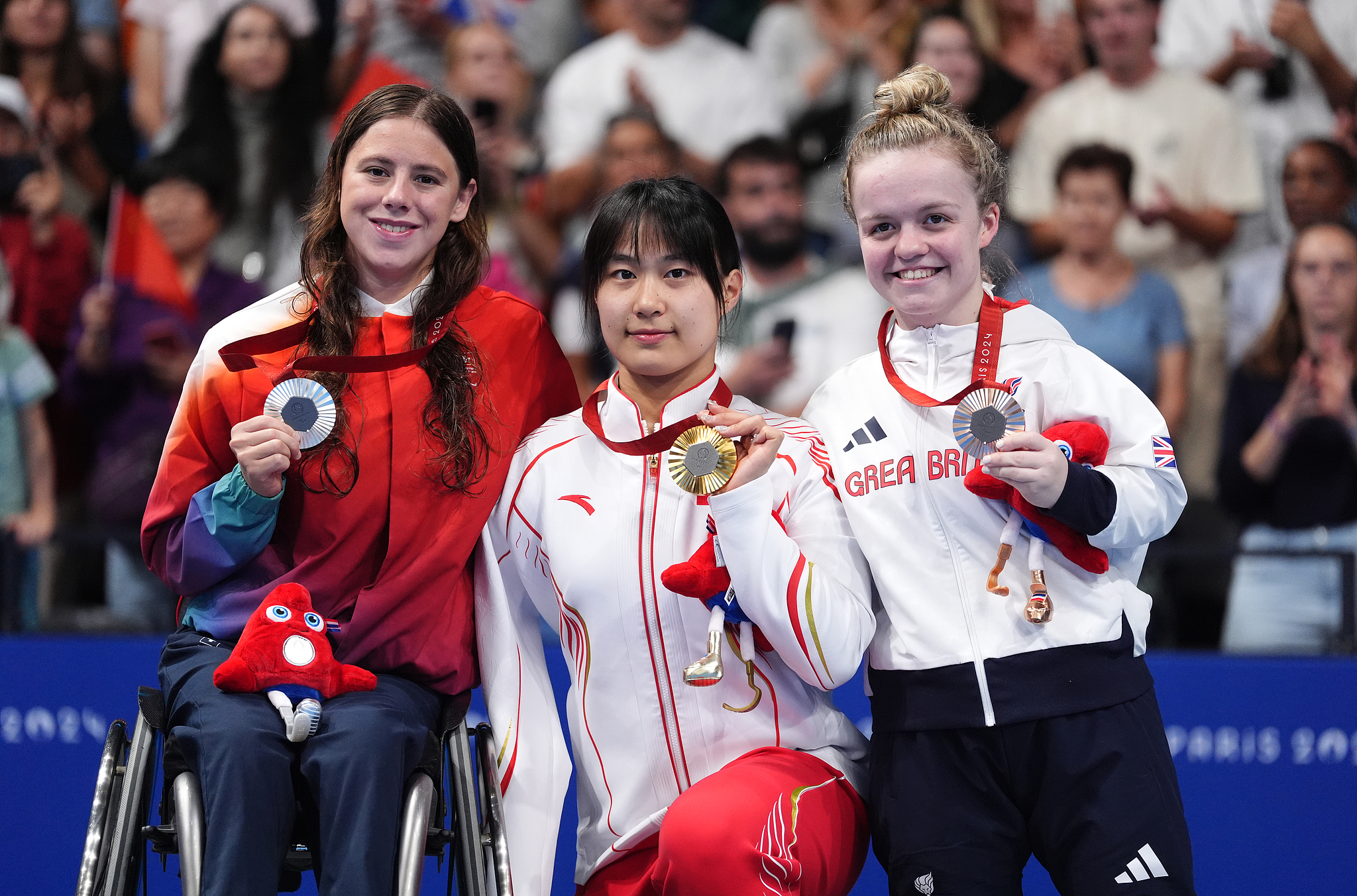 China's Jiang Yuyan (center) with the gold medal, alongside Switzerland's Nora Meister (left) with silver and Great Britain's Maisie Summers-Newton with bronze after the Women's 400m Freestyle - S6 Final at the Paris 2024 Paralympics. /via CFP