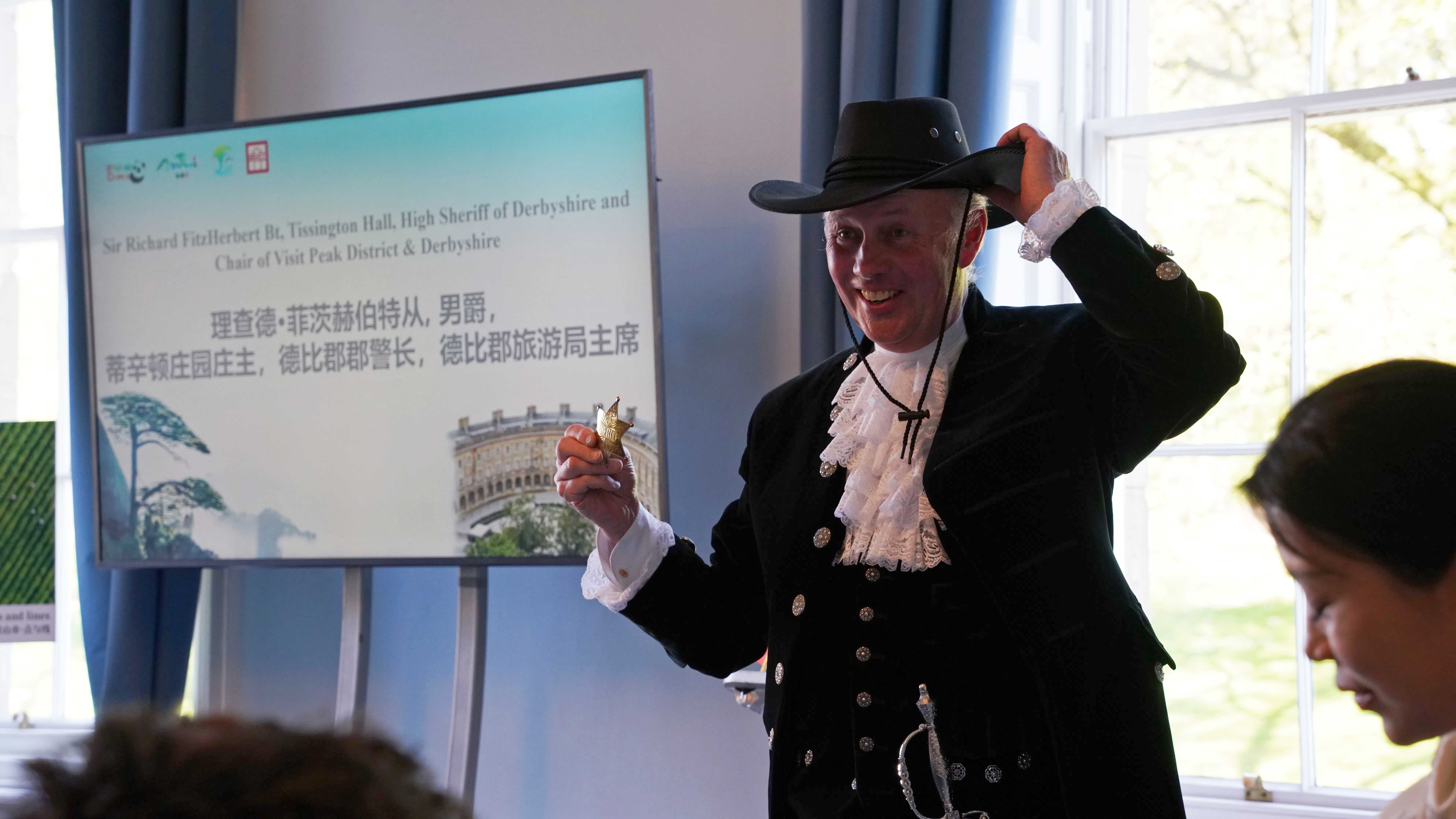 Sir Richard FitzHerbert, chair of Visit Peak District and Derbyshire, introduces his outfit at the event. /CGTN Europe