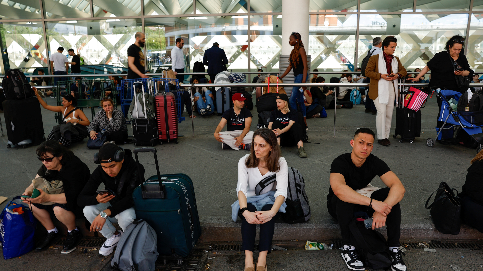 Travellers wait outside Atocha train station after it was closed due to a power outage in Madrid, Spain, April 28, 2025. /REUTERS/Susana Vera