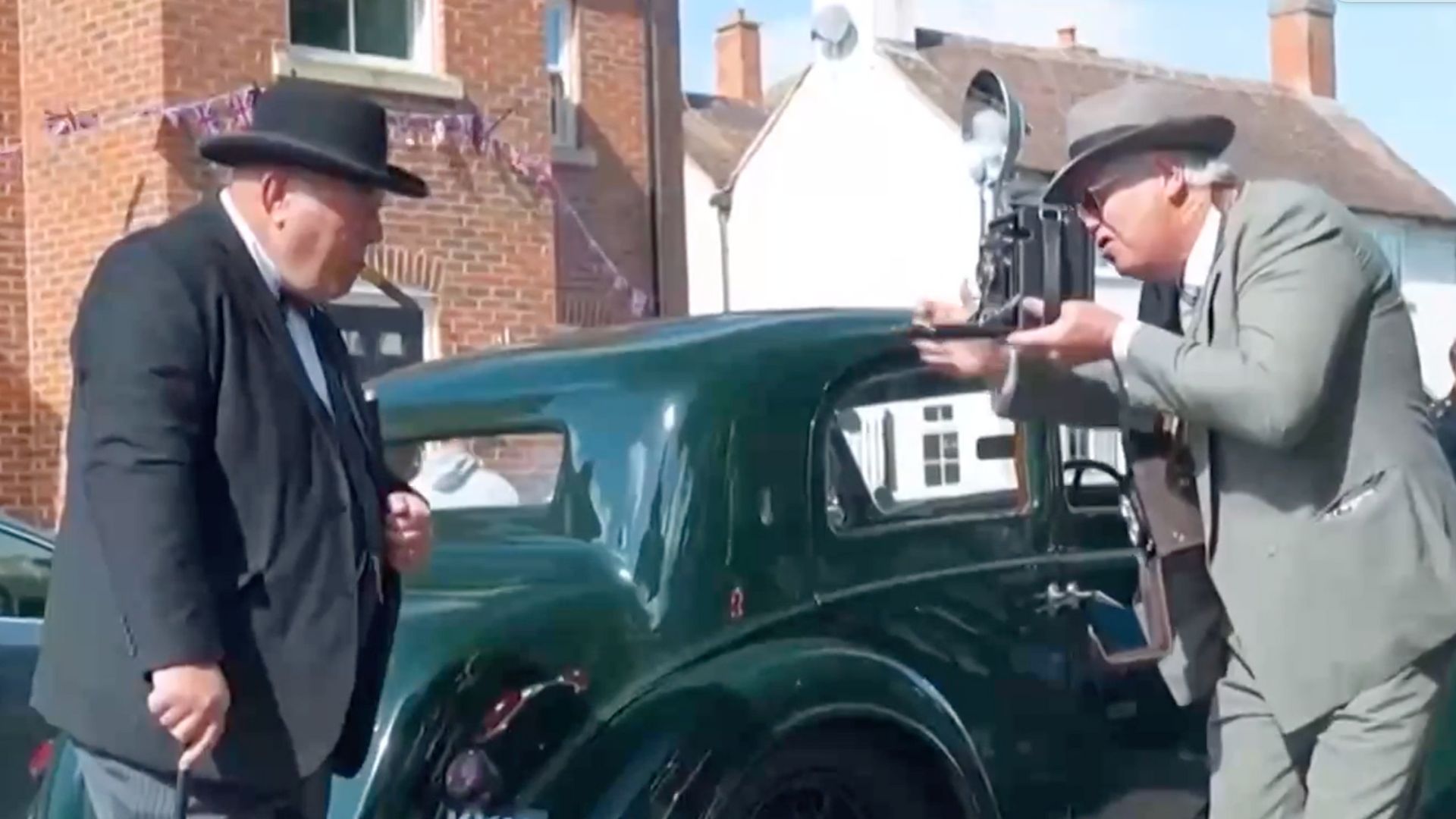 An attendee depicting UK wartime prime minister Winston Churchill being photographed with an old-fashioned camera. /CGTN 