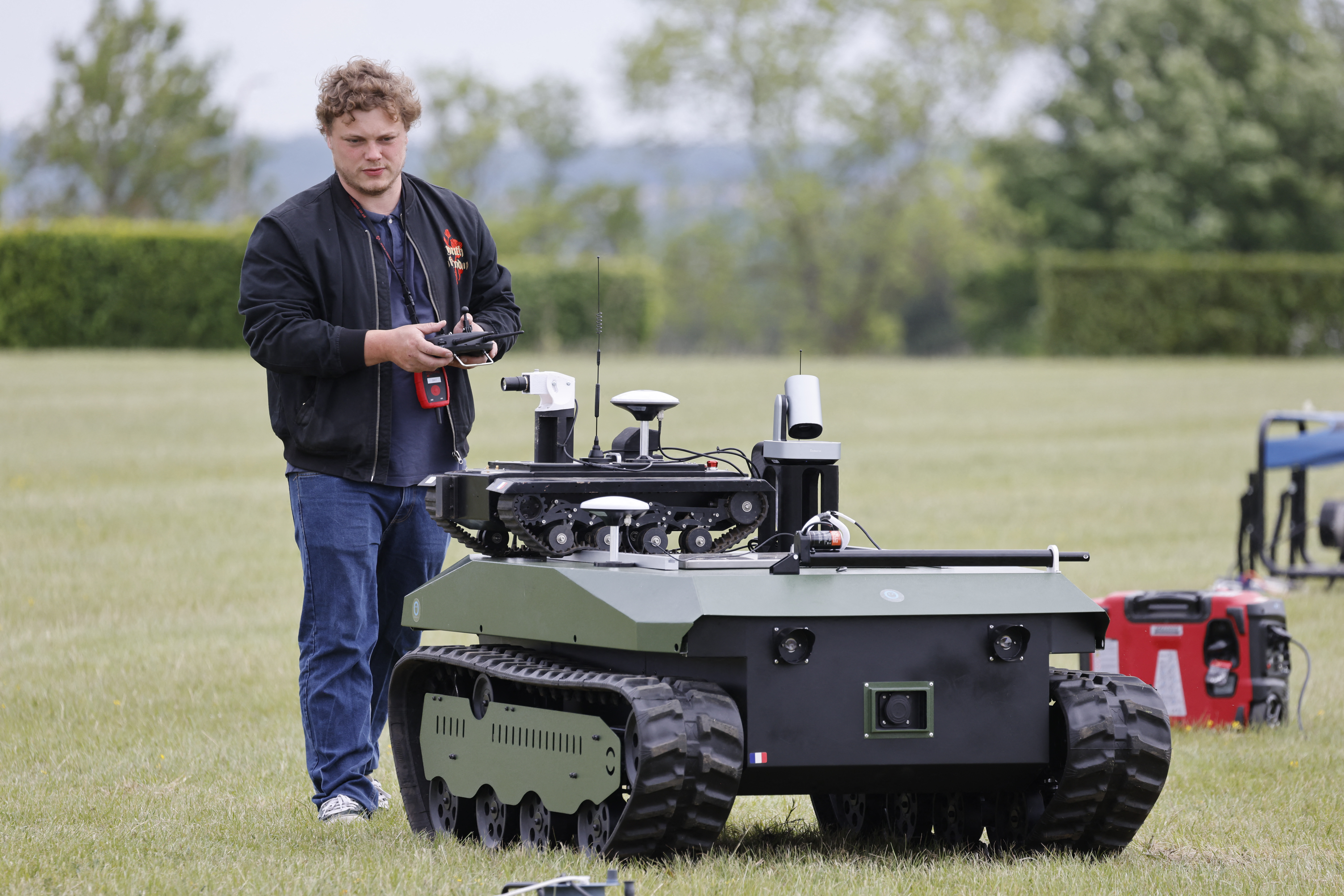 An engineer performs a demonstration of experimentals combat robots during the CoHoMa challenge event. /Ludovic Marin/AFP
