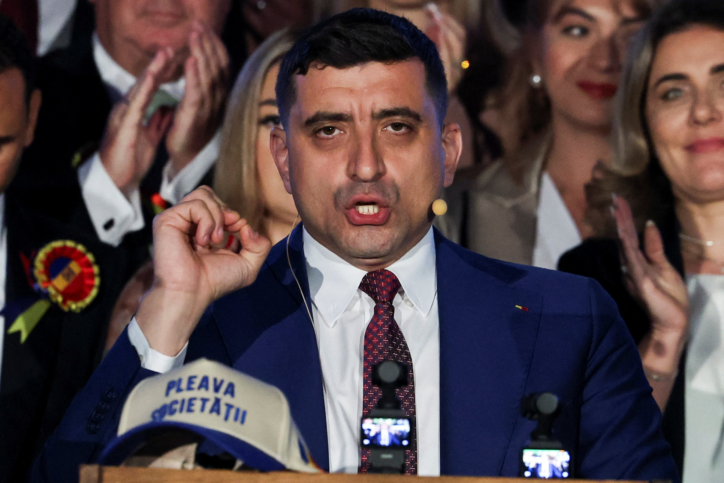 Presidential candidate George Simion reacts to exit polls of Romania's second round of the presidential election. /Louisa Gouliamaki/Reuters