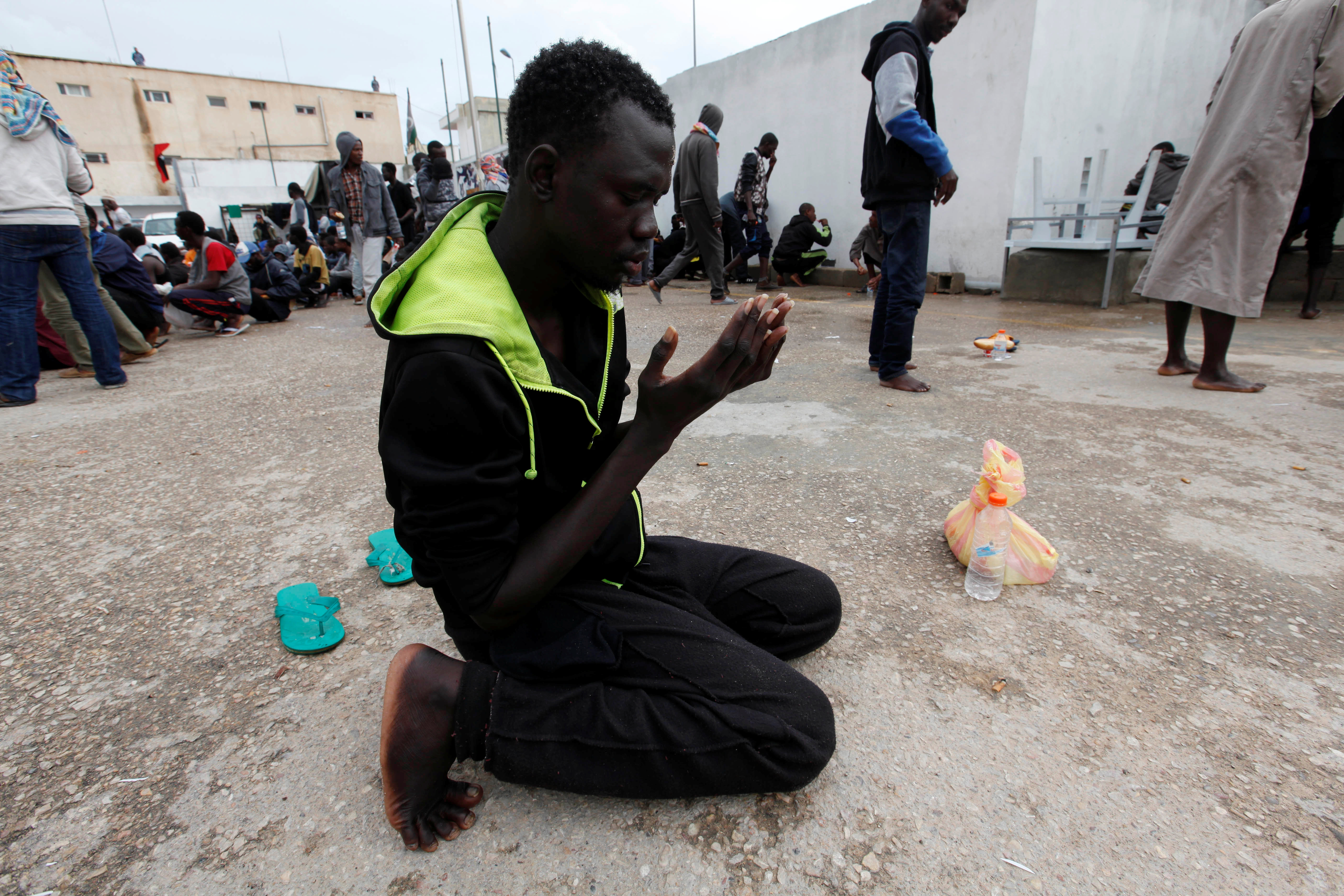 A migrant prays at a detention camp in Tripoli, Libya. /Ismail Zitouny/Reuters