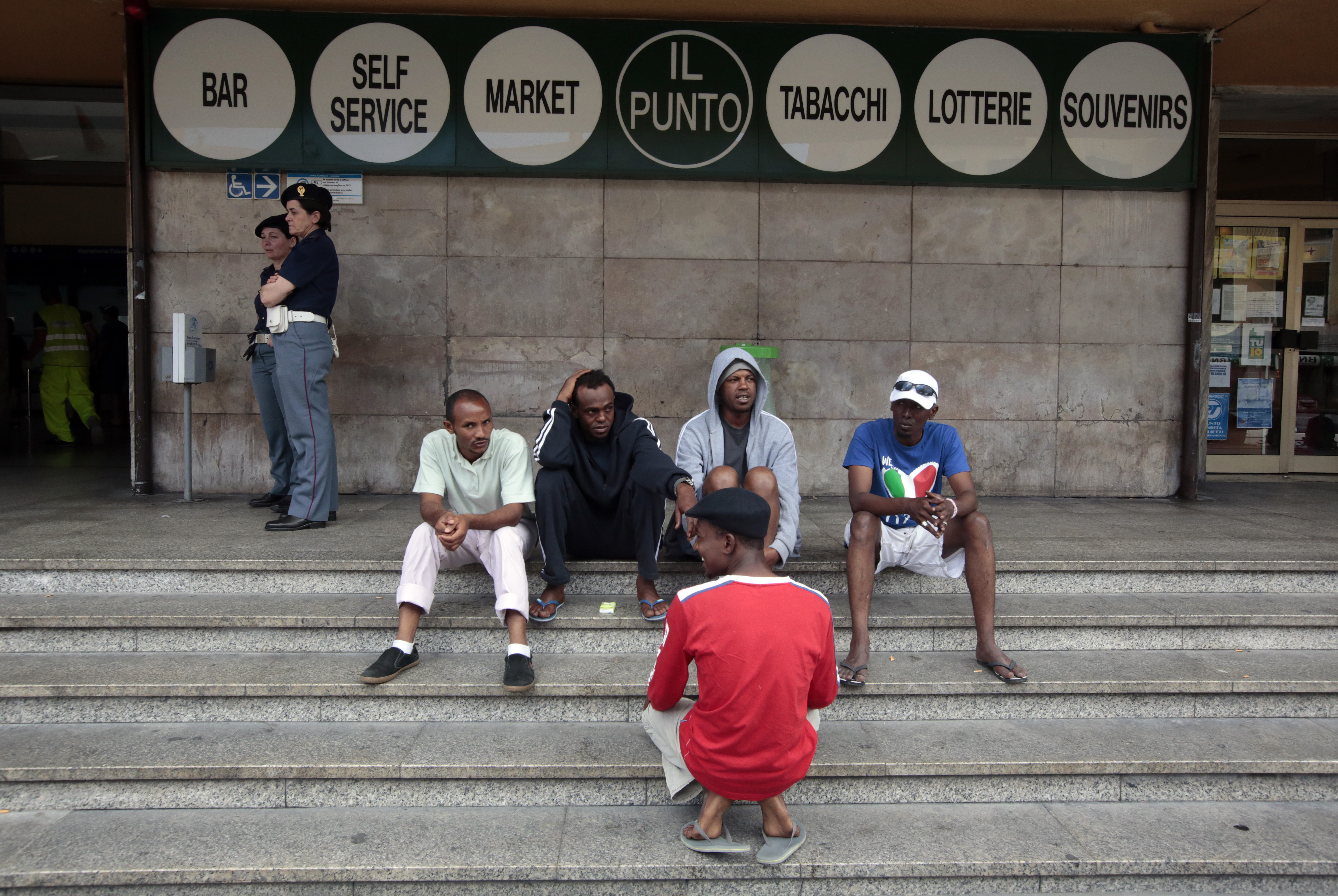 A group of migrants sit in front of Ventimiglia railway station, Italy. /Eric Gaillard/Reuters
