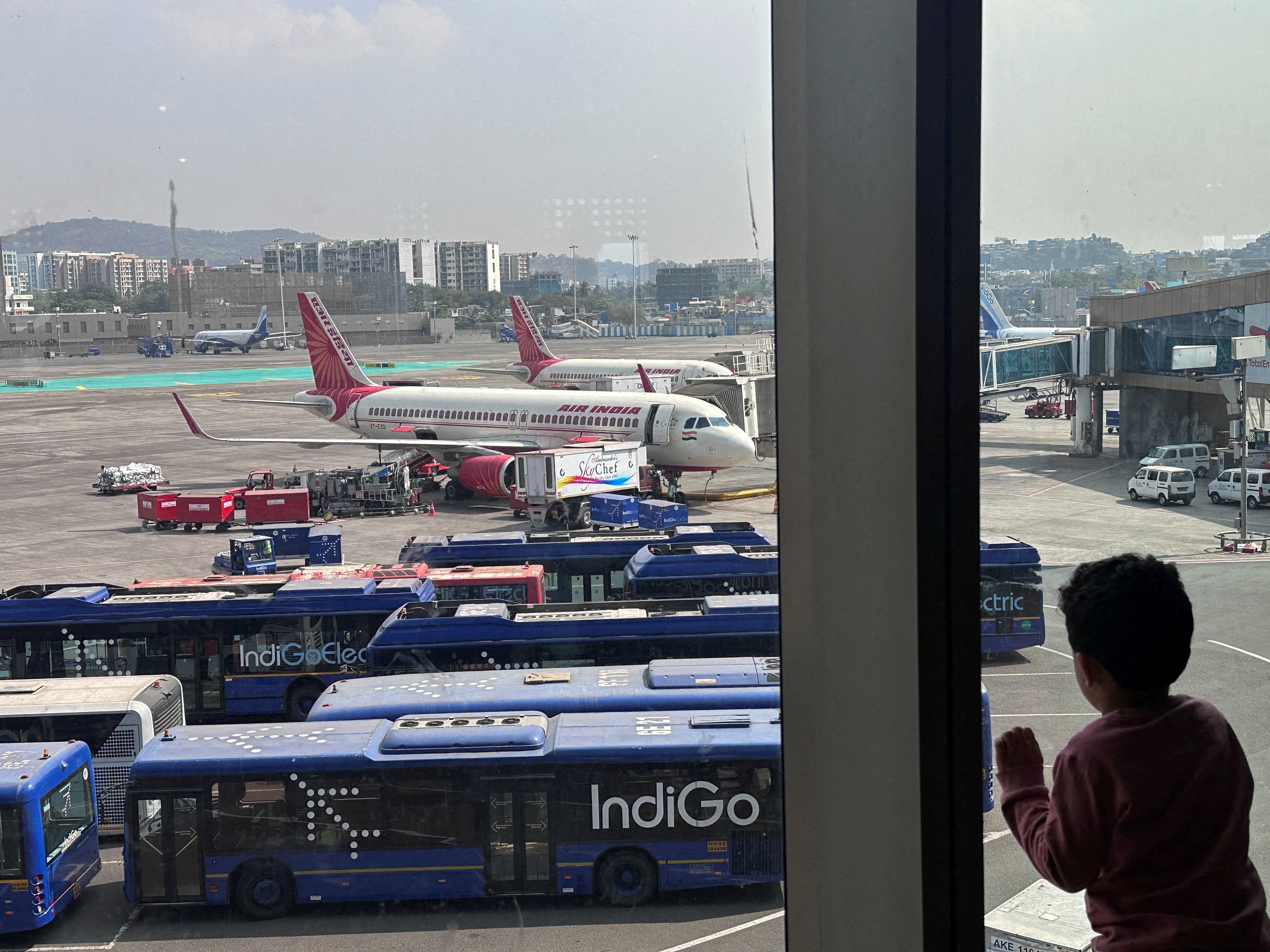  A boy looks at Air India airline passenger aircrafts parked at the Chhatrapati Shivaji Maharaj International Airport in Mumba. /Francis Mascarenhas/File/reuters