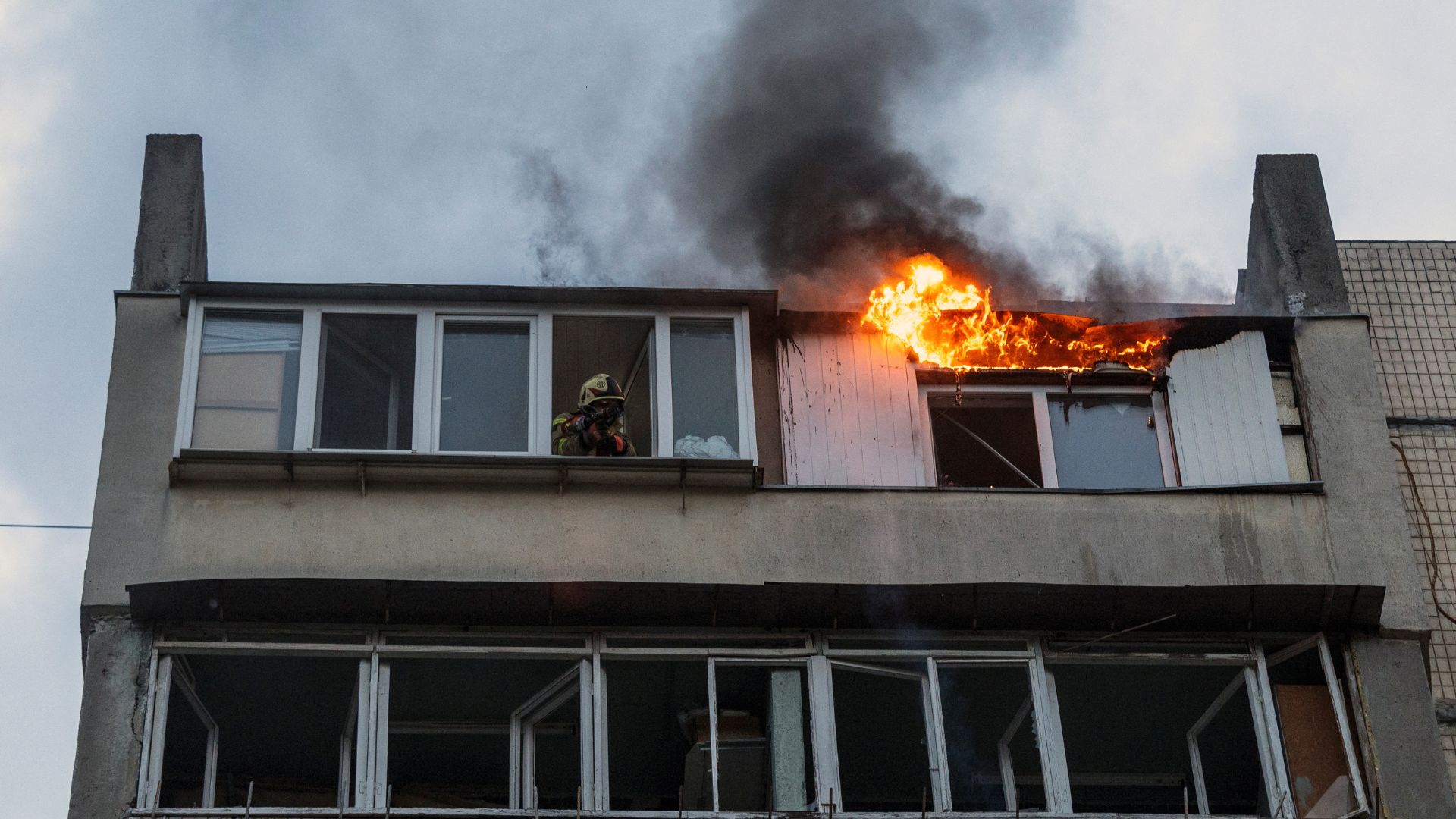 Flames burst from an apartment building damaged during a Russian drone strike on Kyiv. /Thomas Peter/Reuters
