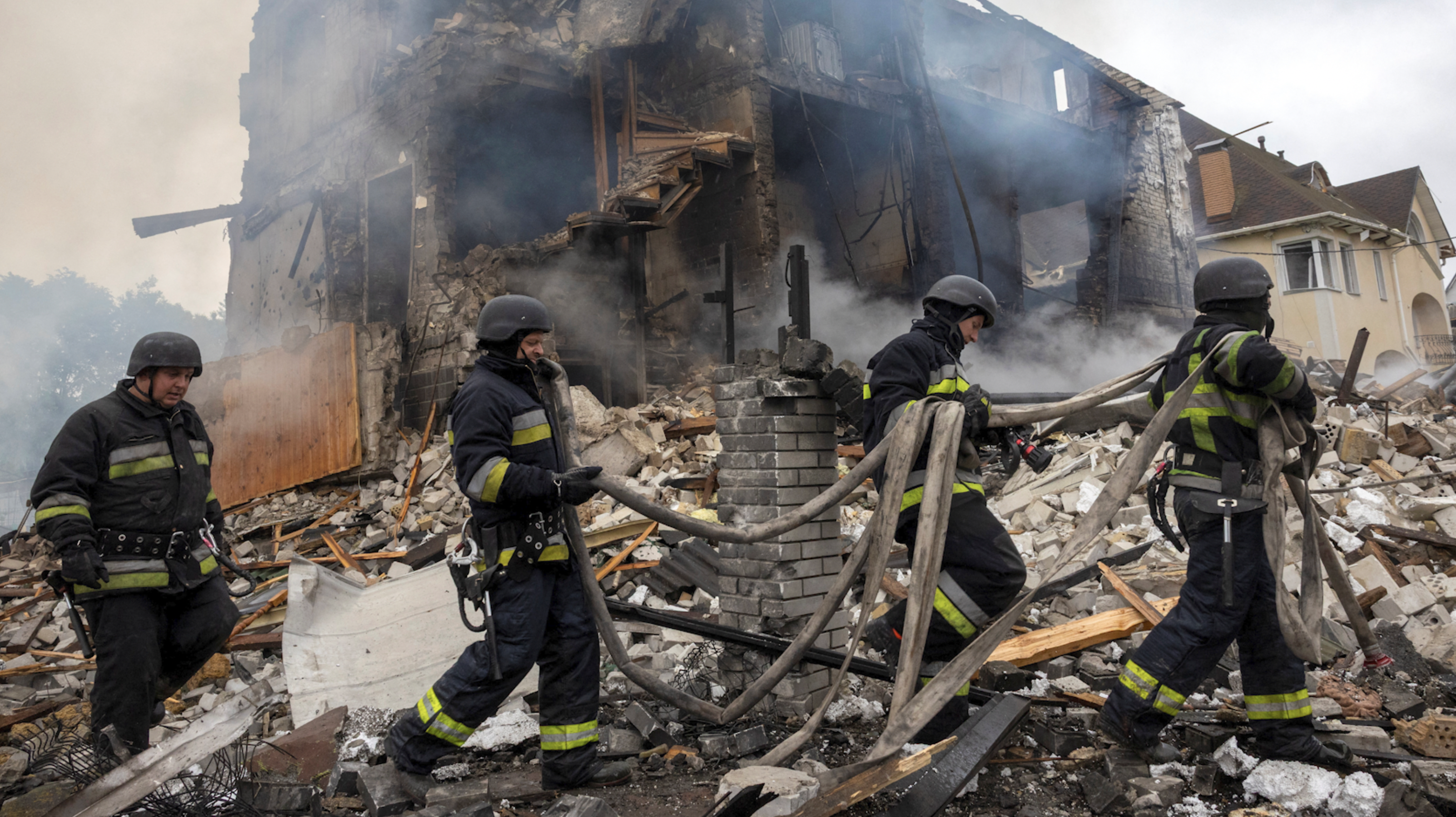 Emergency workers work at the site where private houses were destroyed in a Russian rocket strike. /Reuters