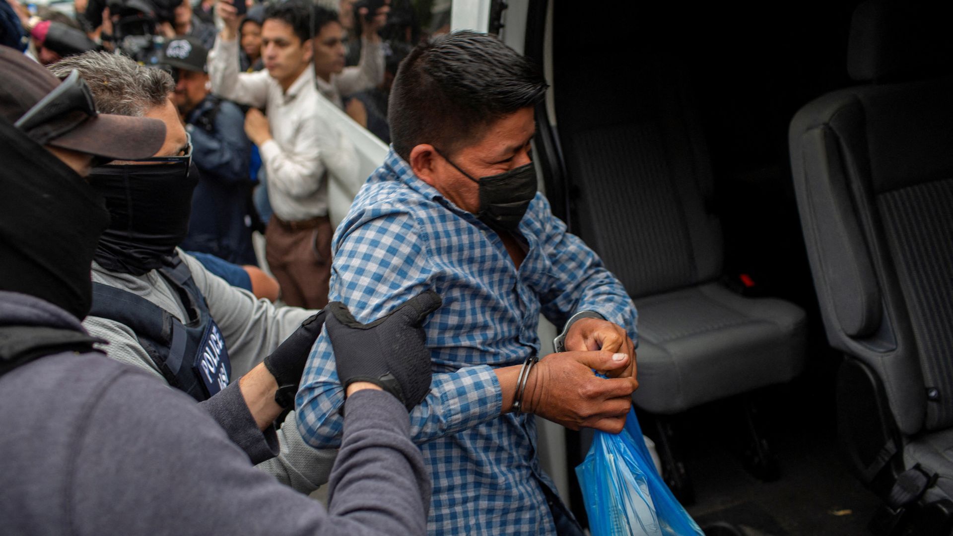 A man is loaded into a passenger van by federal agents after the agents made immigration arrests in Chicago, Illinois, U.S. on June 4. /Jim Vondruska/Reuters 