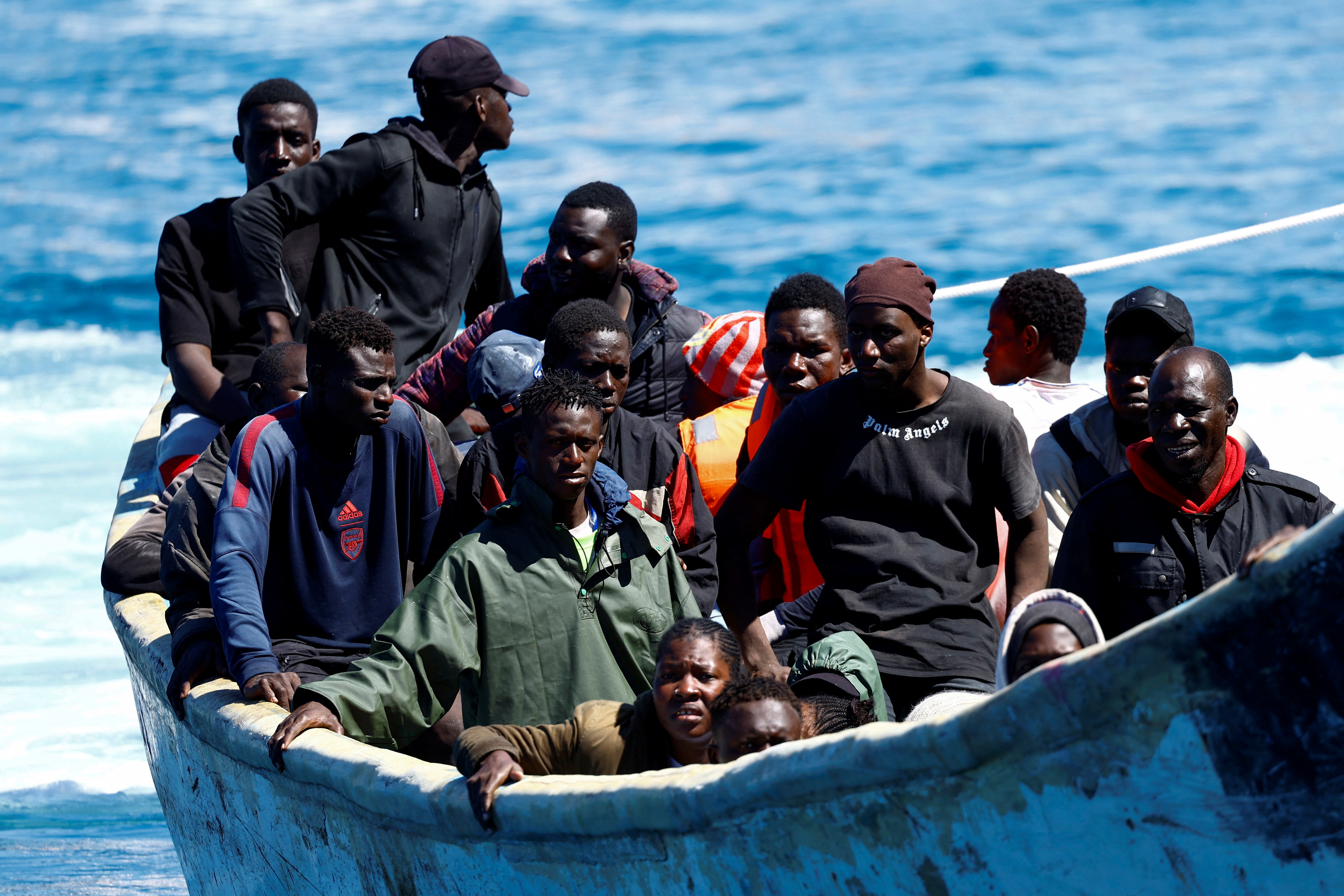 African migrants wait to disembark from a boat in the port of Arguineguin, on the island of Gran Canaria, Spain last year./ Borja Suarez/Reuters