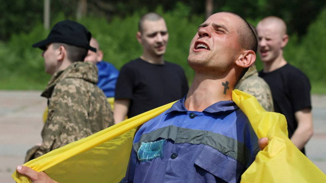 Ukrainian prisoners return home at an unknown location. /Zelenskyy/via Telegram/Handout/Reuters 