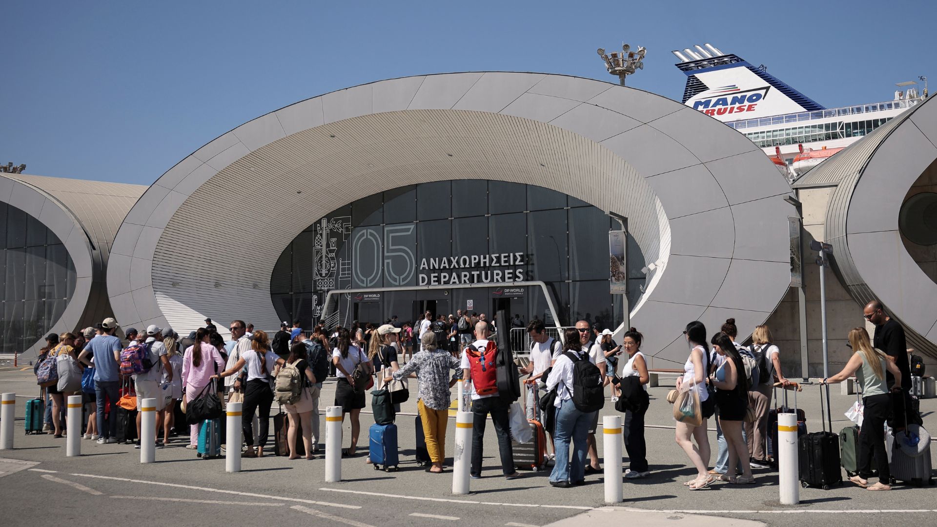 People wait to board Crown Iris, a cruise ship which will be used to assist in the departure of Israelis from Cyprus, at the port in Limassol, Cyprus. /Yiannis Kourtoglou/Reuters