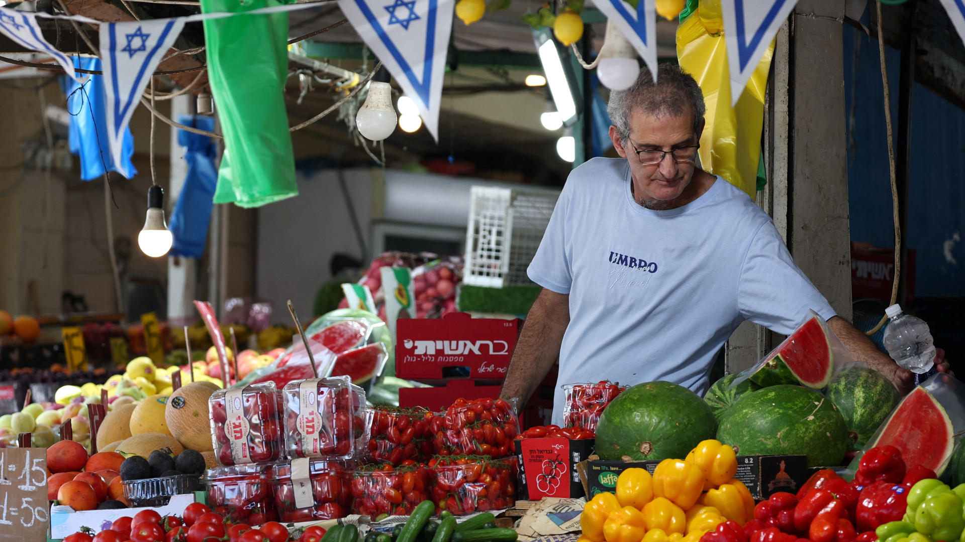 An Israeli man tends to his shop, after U.S. President Donald Trump announced a ceasefire between Israel and Iran in Haifa, Israel, June 24. /Florion Goga/Reuters
