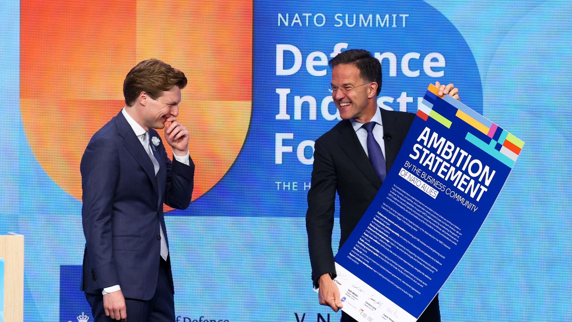 NATO Secretary General Mark Rutte holds 'Ambition Statement by the Business Community of NATO Allies', as Dutch Defence Minister Ruben Brekelmans stands by on the summit sidelines. /Yves Herman/Reuters
