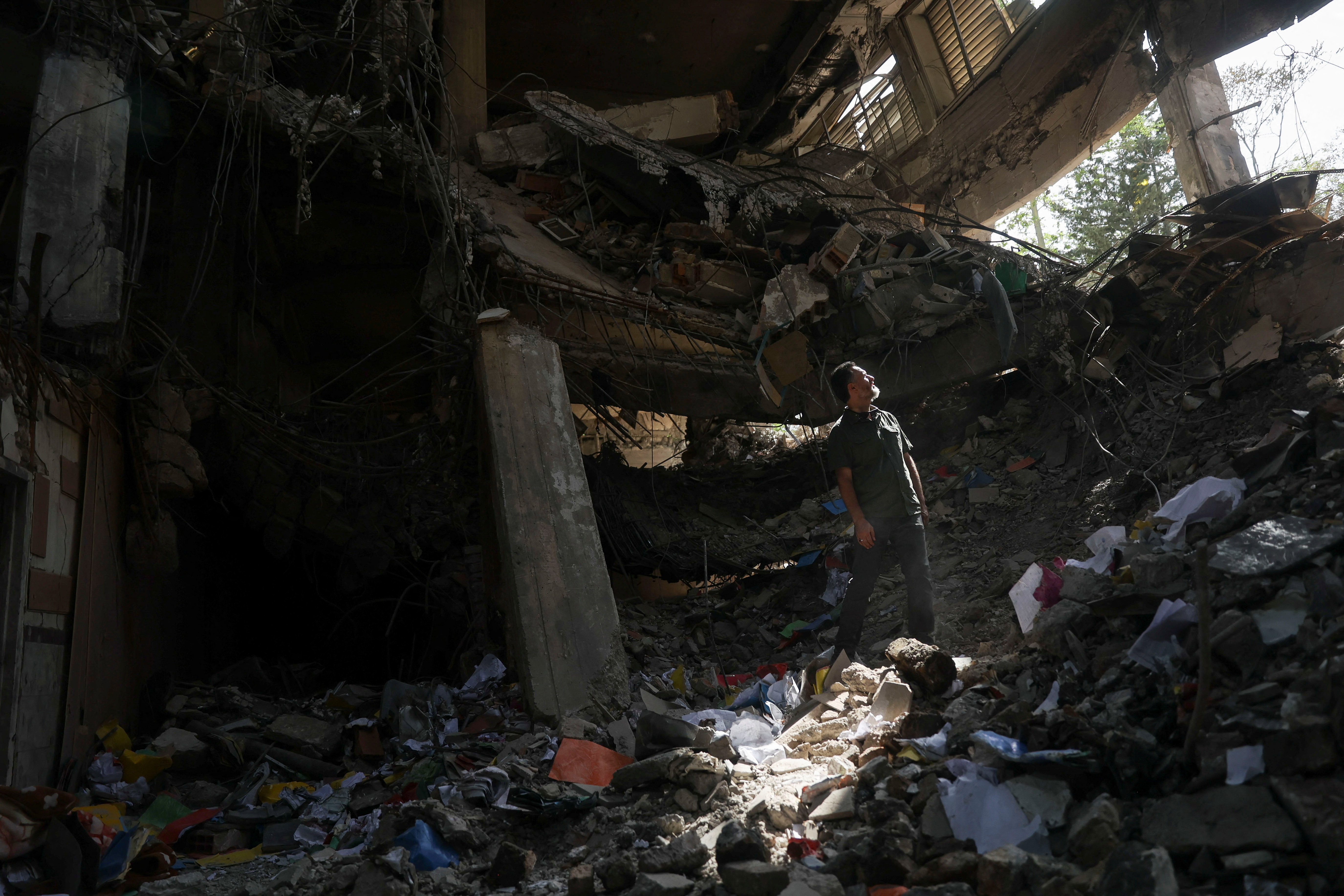 A person stands on the rubble as a view shows the aftermath of an Israeli strike on Evin Prison that took place on June 23. /Reuters