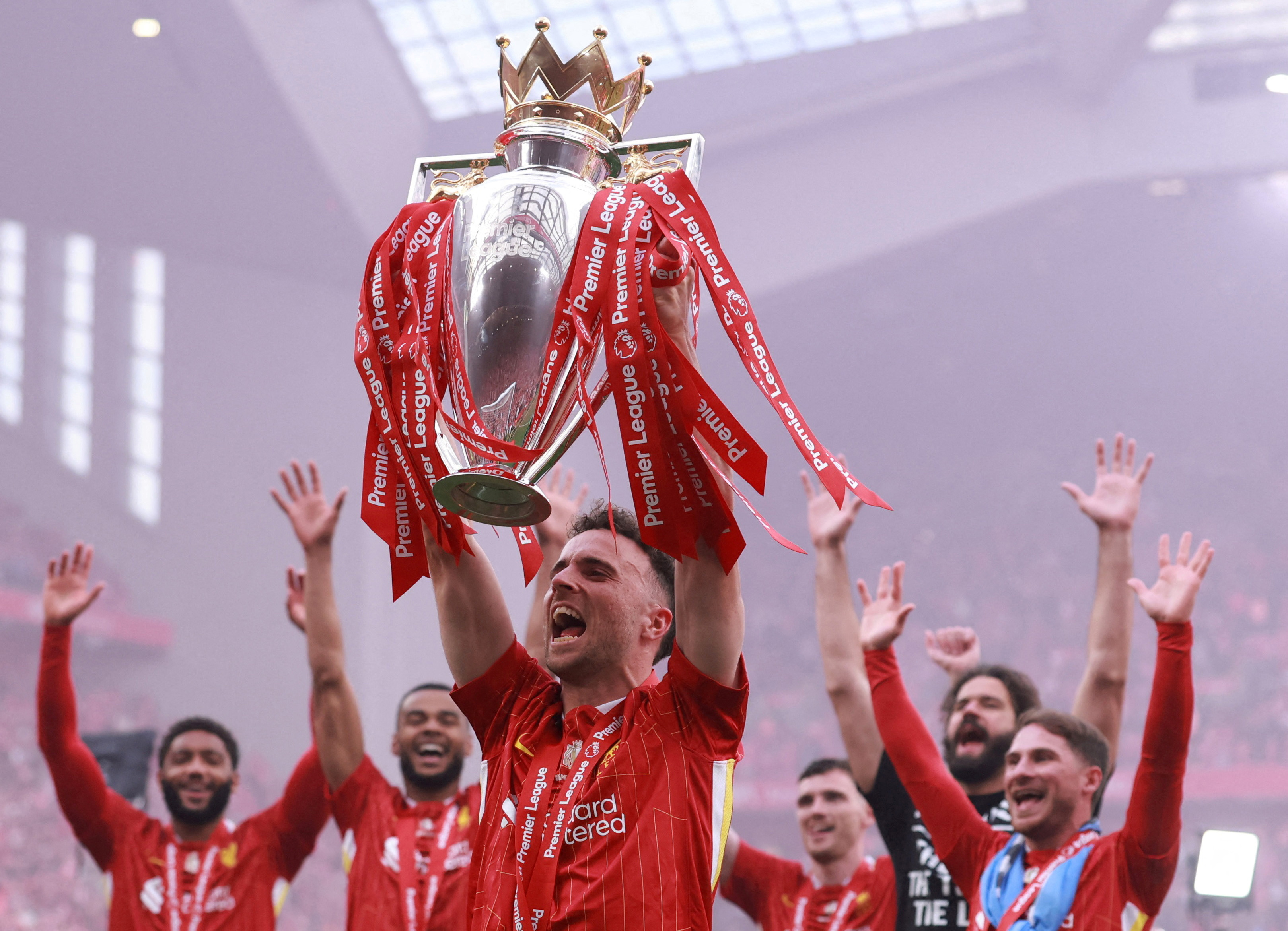 Liverpool's Diogo Jota celebrates with the trophy after winning the Premier League on May 25. /Phil Noble/Reuters
