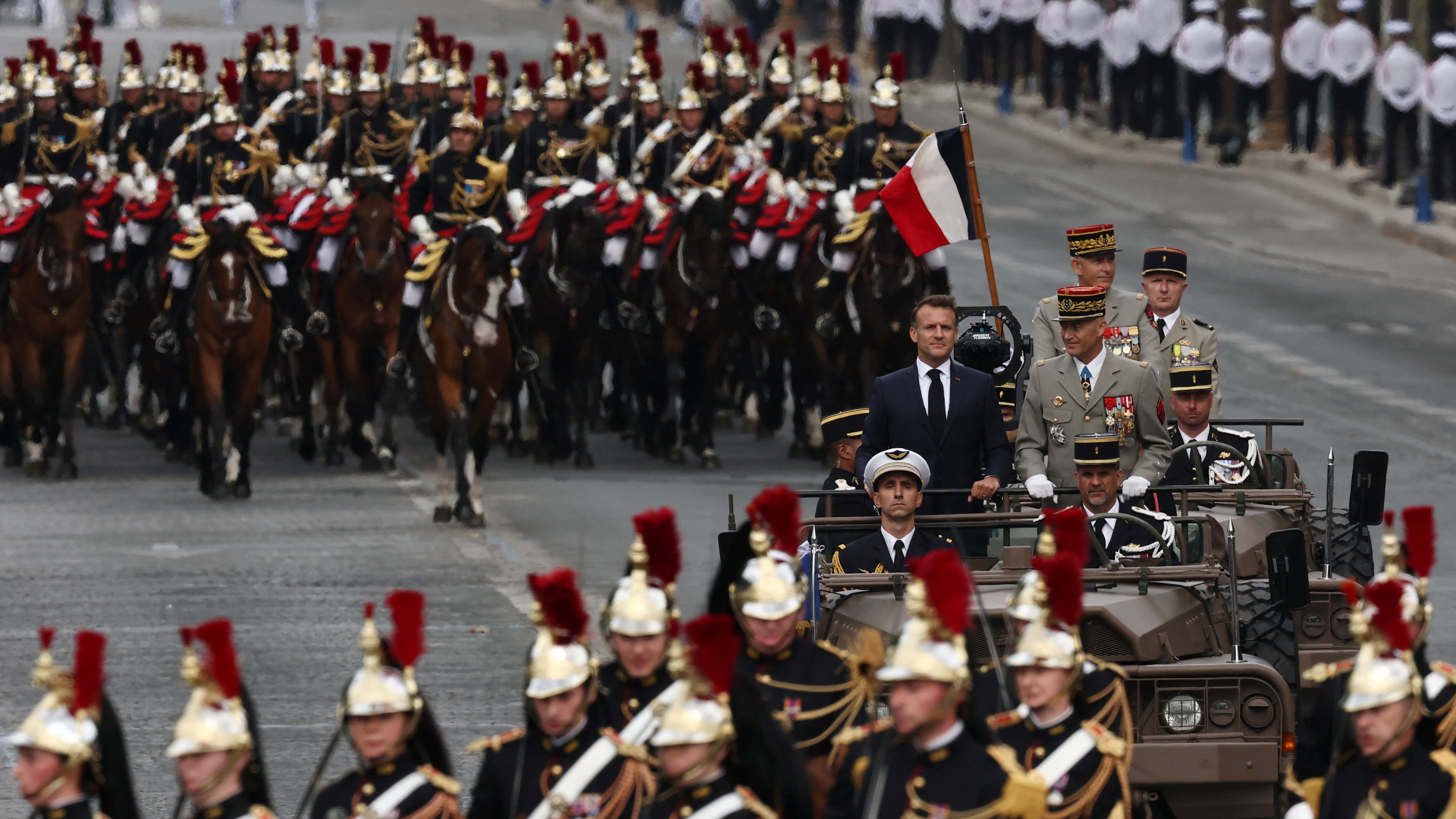 Emmanuel Macron with Chief of Staff of the French Armed Forces during Monday's Bastille Day military ceremony in Paris. /Gonzalo Fuentes/Reuters