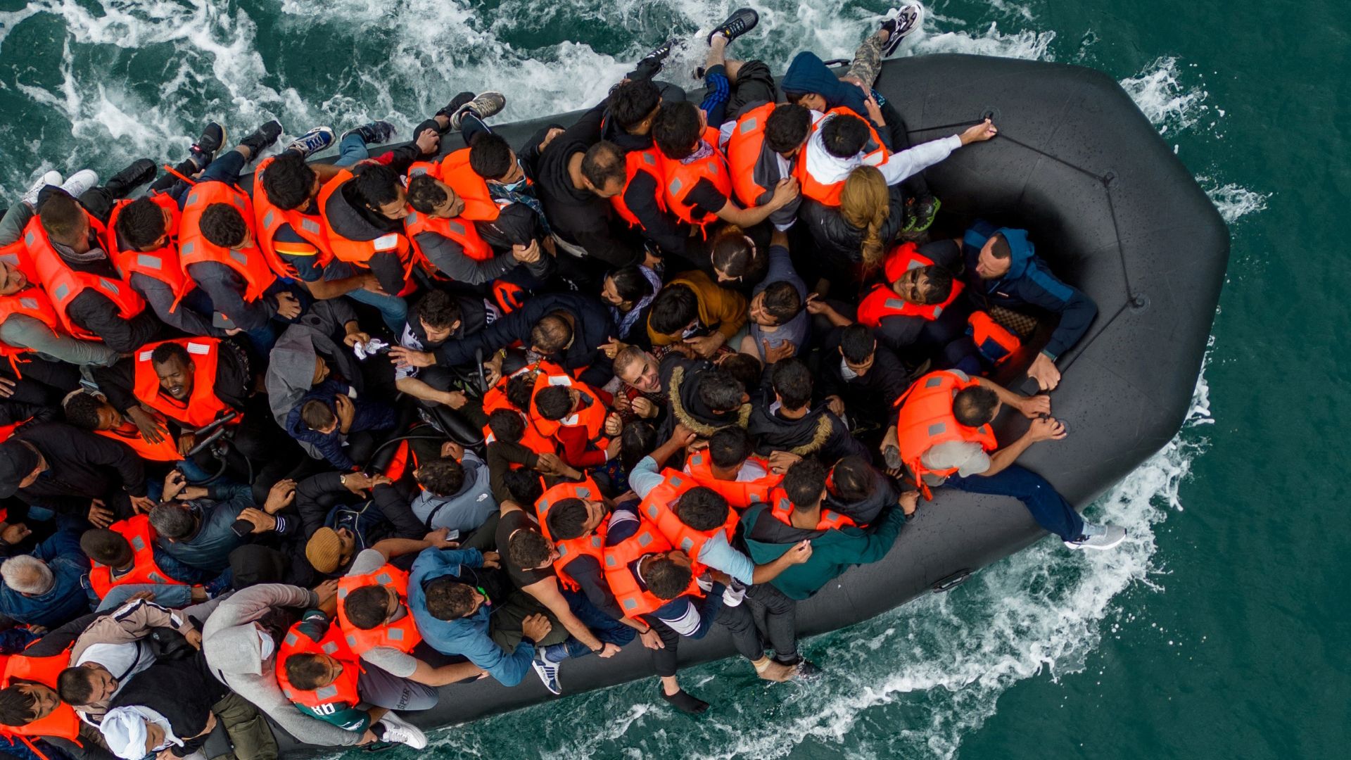 UK says first migrants detained under return deal with France