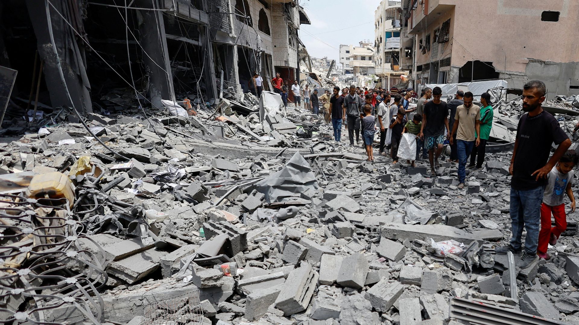 Palestinians inspect the site of a morning Israeli strike on a house in Gaza City, August 8. /Mahmoud Issa/Reuters