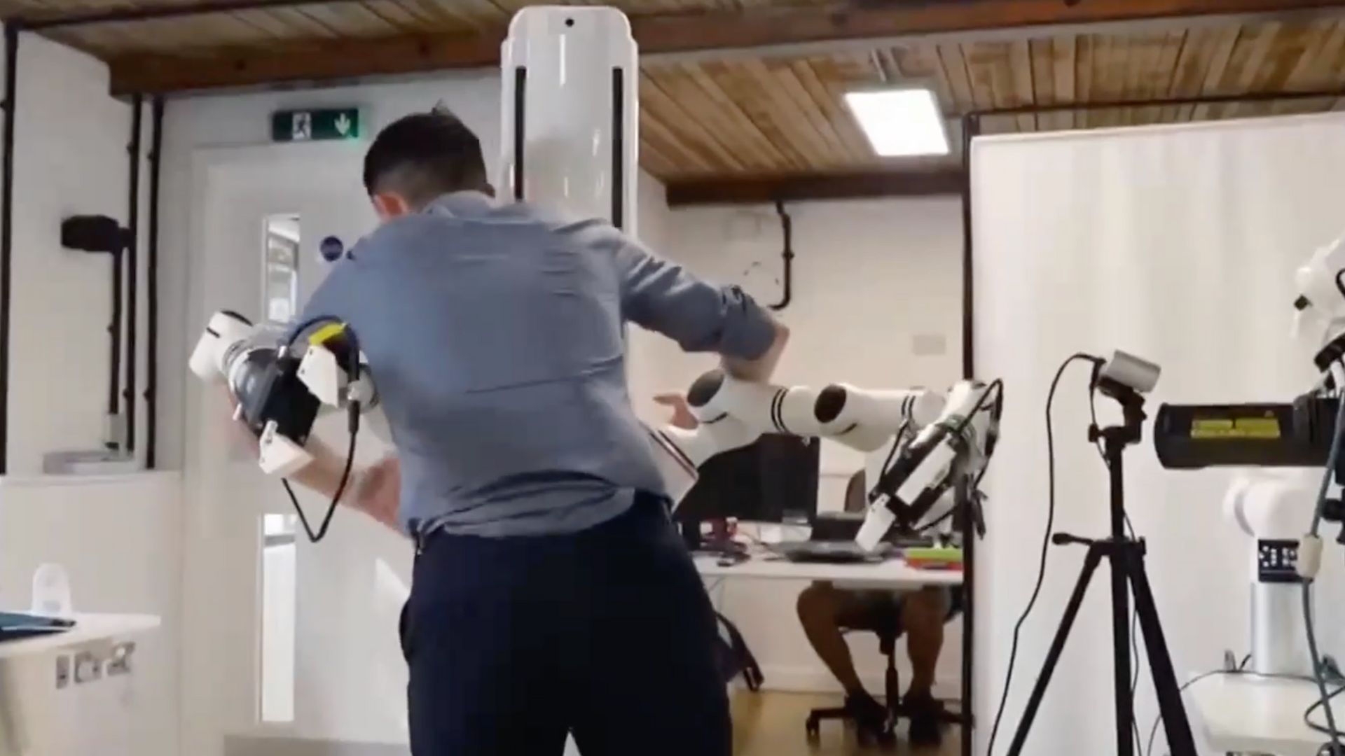 Michael Marillier leans in for a robotic hug. /CGTN