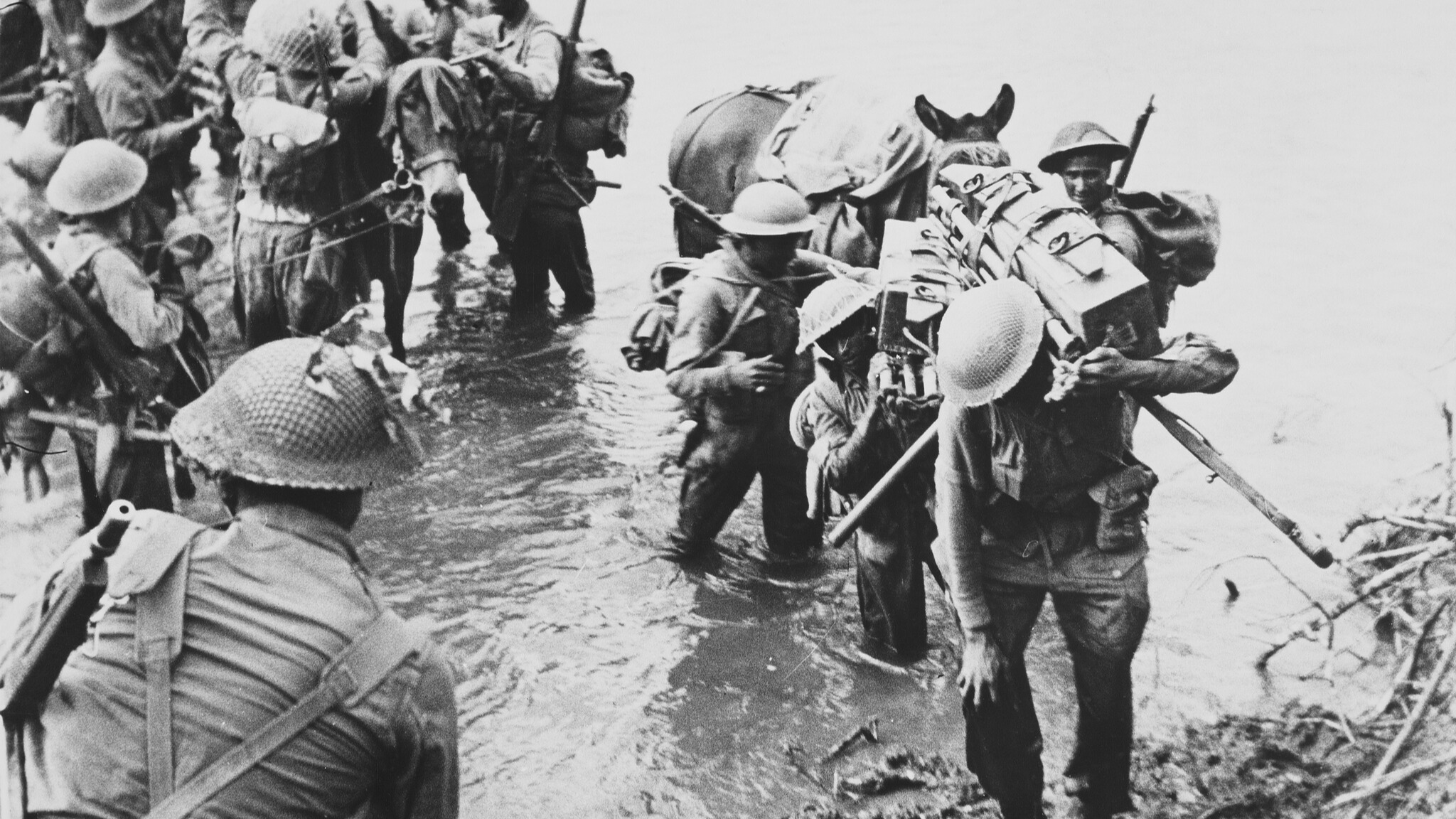 Indian troops of the 26th Indian Brigade, 36th Indian Infantry Division of the British 14th Army unloading ammunition boxes and supplies from pack mules climb the riverbank after crossing the Nammeiit River at Myitson, Burma, circa March 1945. /Archive Photos/Getty Images
