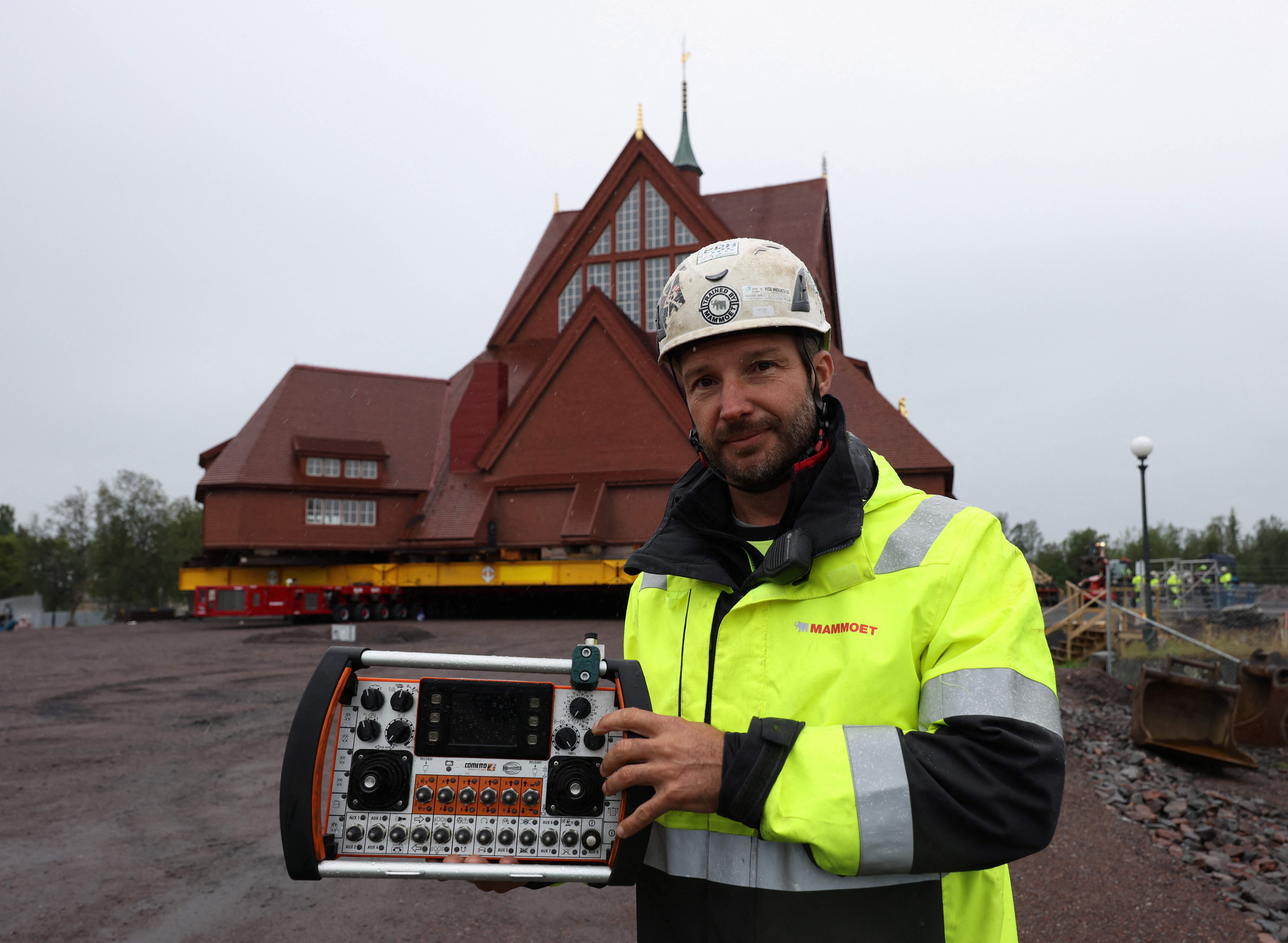 Operator Kees Breedveld with the remote control panel of the machinery which will be used to relocate the Kiruna's historic wooden church. /Leonhard Foeger/Reuters
